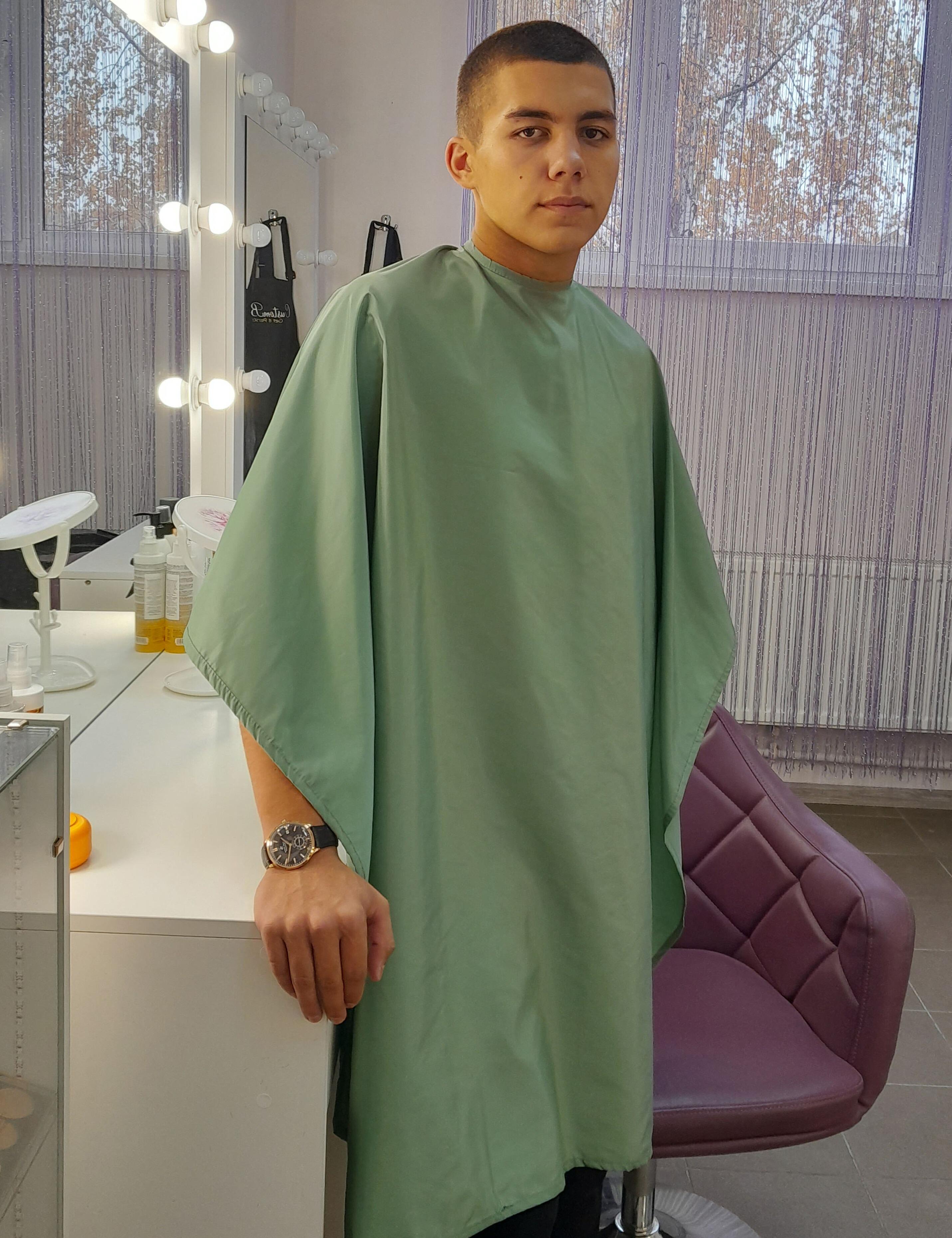 Olive barber cape tailored for trendy US hair studios