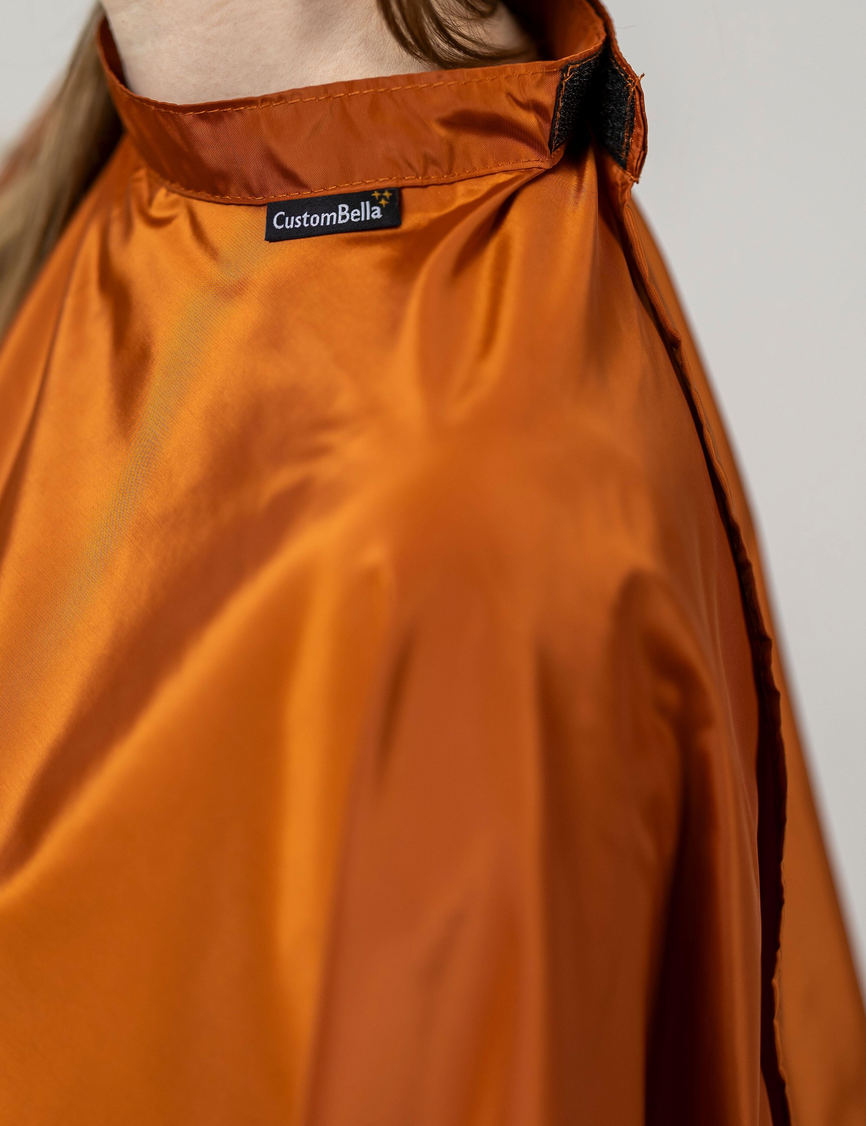 Ginger biscuit kids salon cape featuring an easily adjustable velcro collar wrap