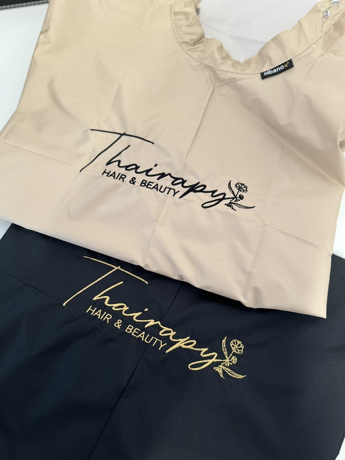Premium embroidered black salon cape for professional barbershops