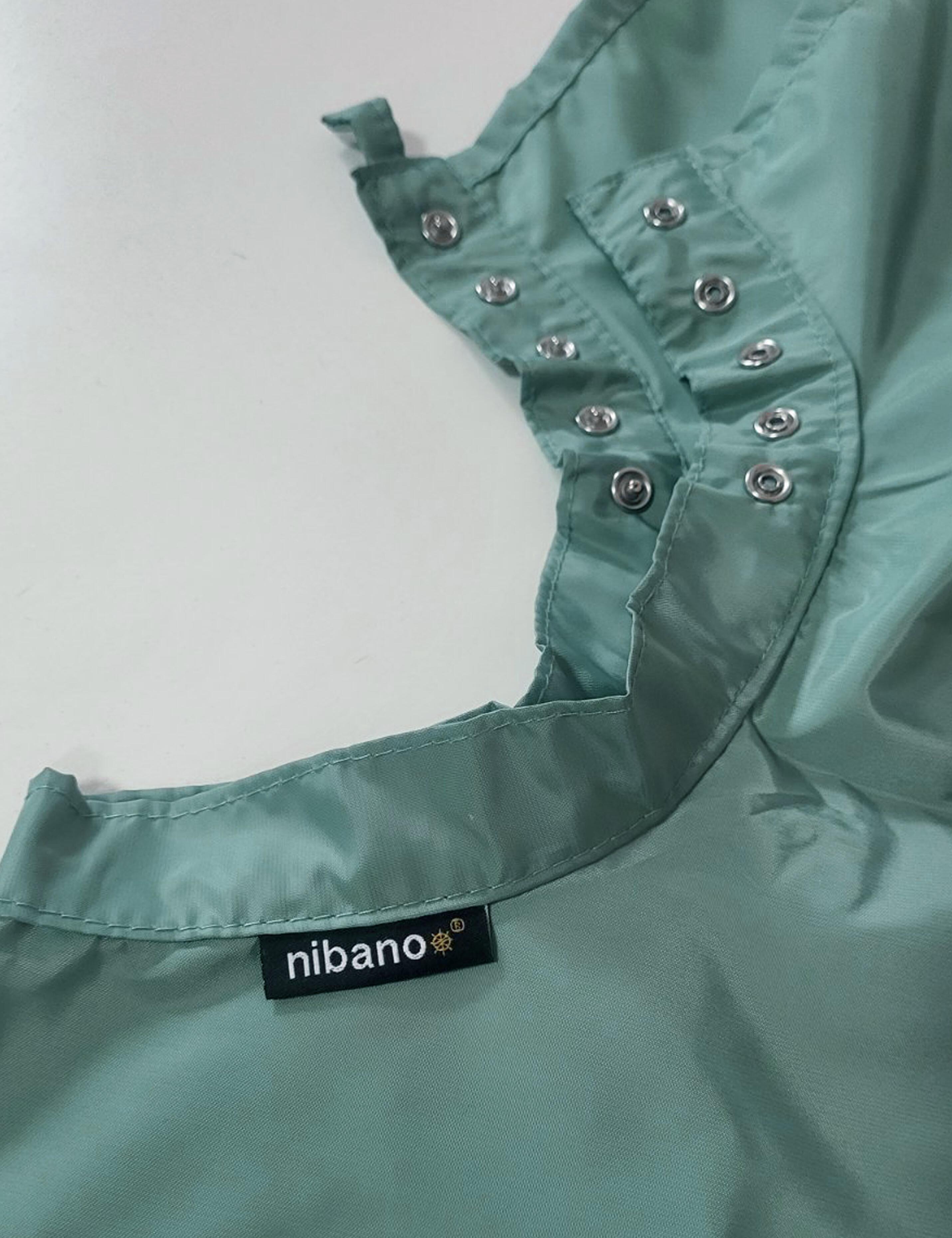 Sage green styling cape outfitted with durable heavy-duty snap fasteners