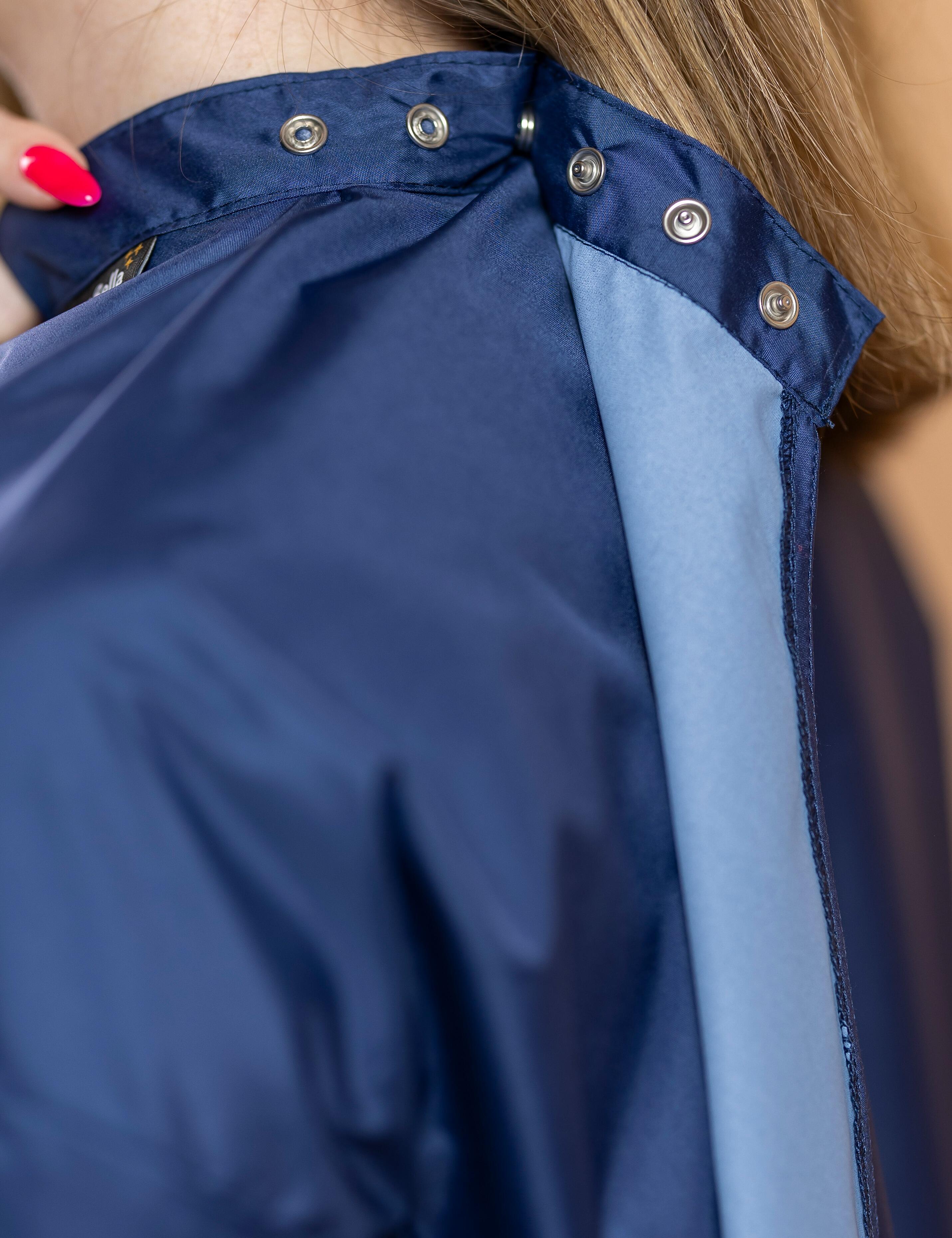 Navy blue salon uniform cape with sleeves personalized with a custom embroidered business logo