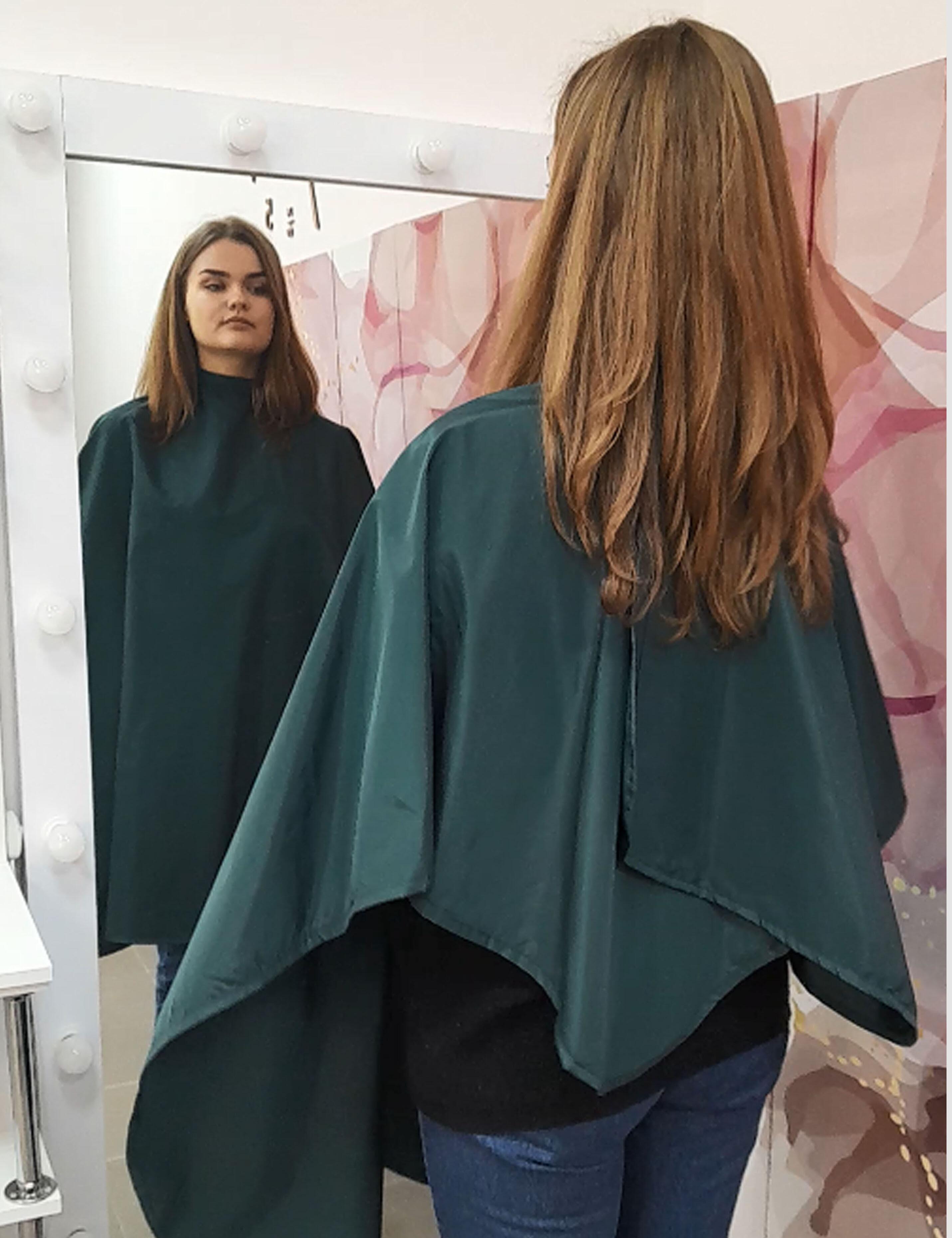 Durable bottle green salon cape designed to protect client clothes during hair treatments