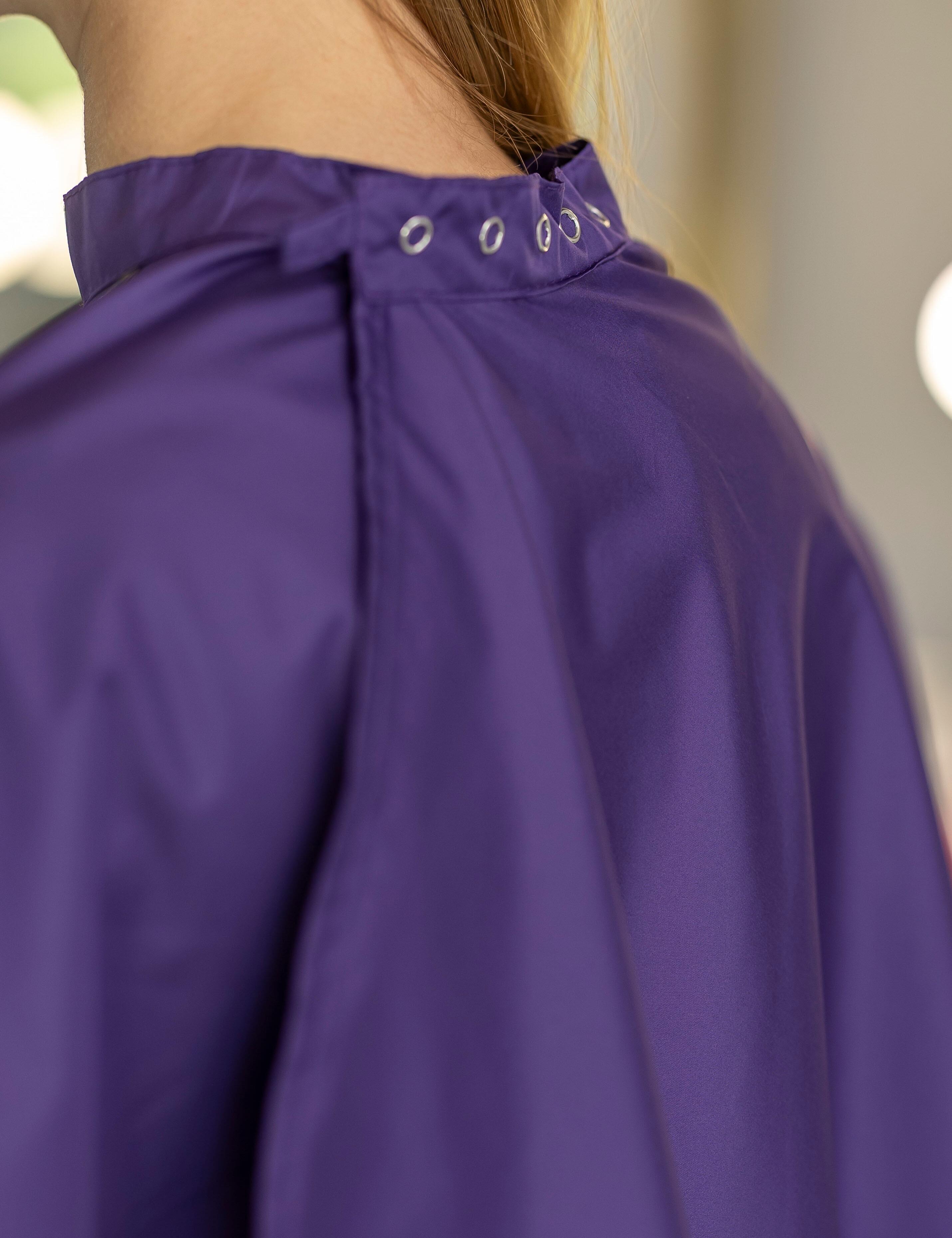 Purple styling cape outfitted with durable heavy-duty snap fasteners.