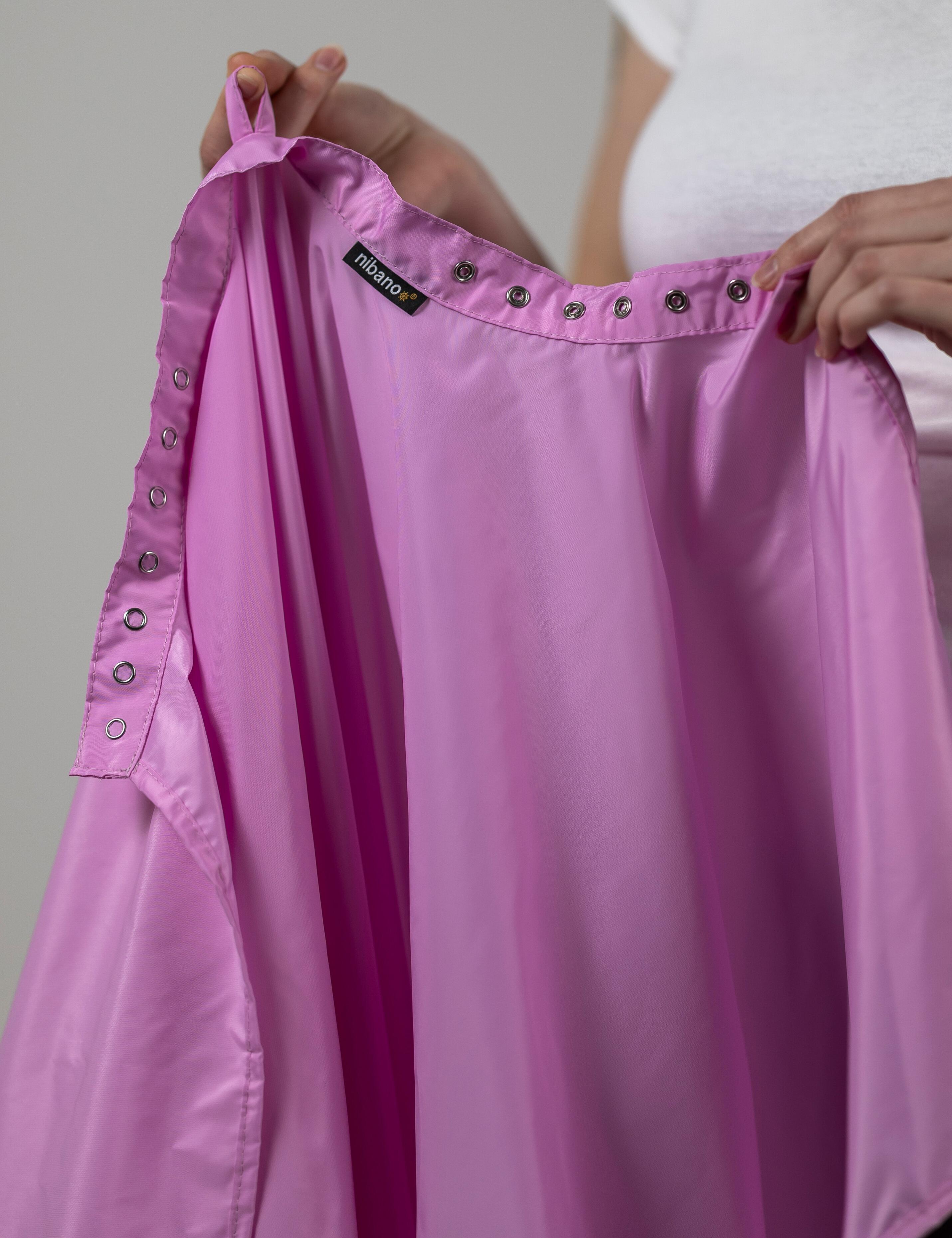 Pink styling cape outfitted with durable heavy-duty snap fasteners.