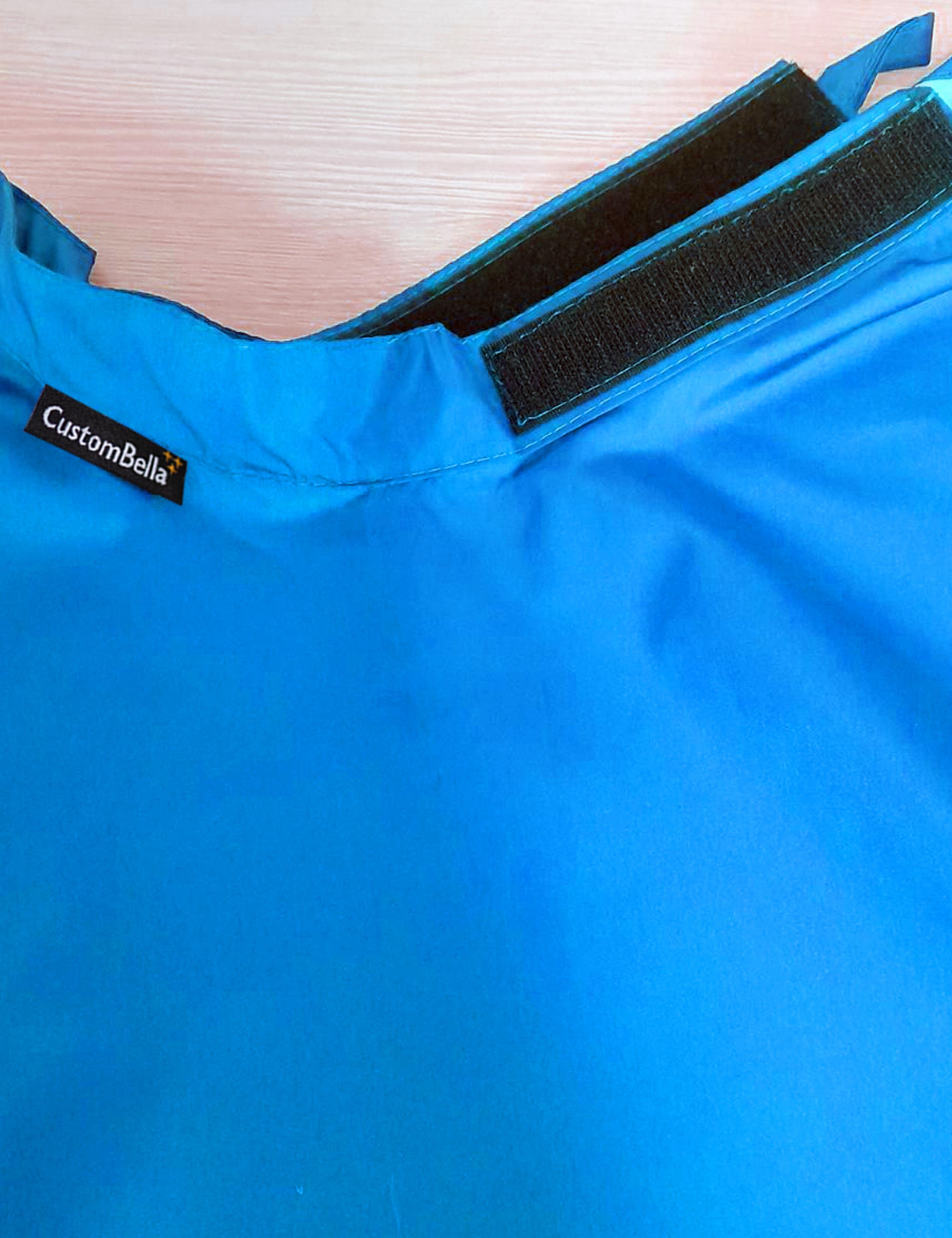 Turquoise kids salon cape with an adjustable velcro neck closure