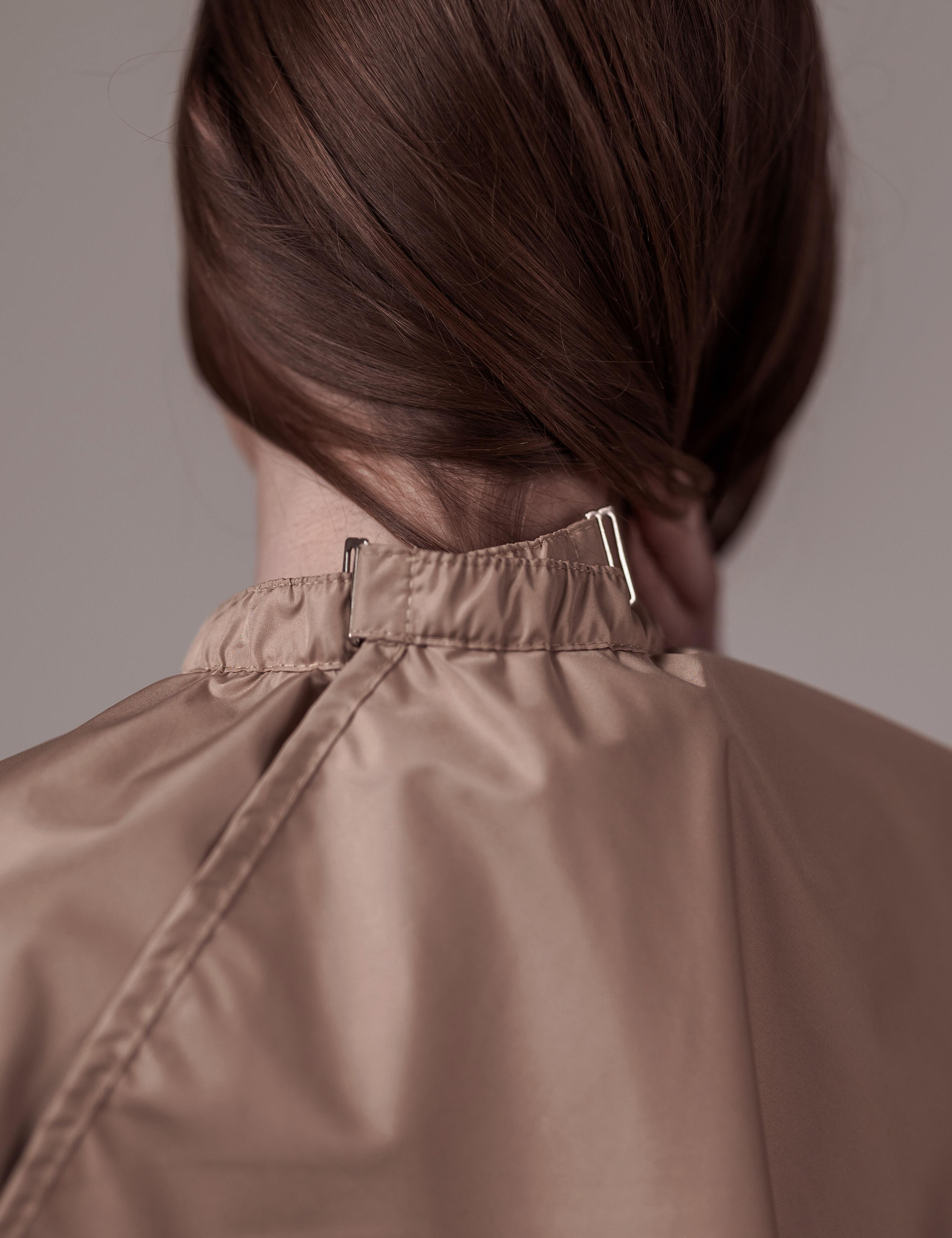 Coffee salon cape with hand slits and secure clip closure