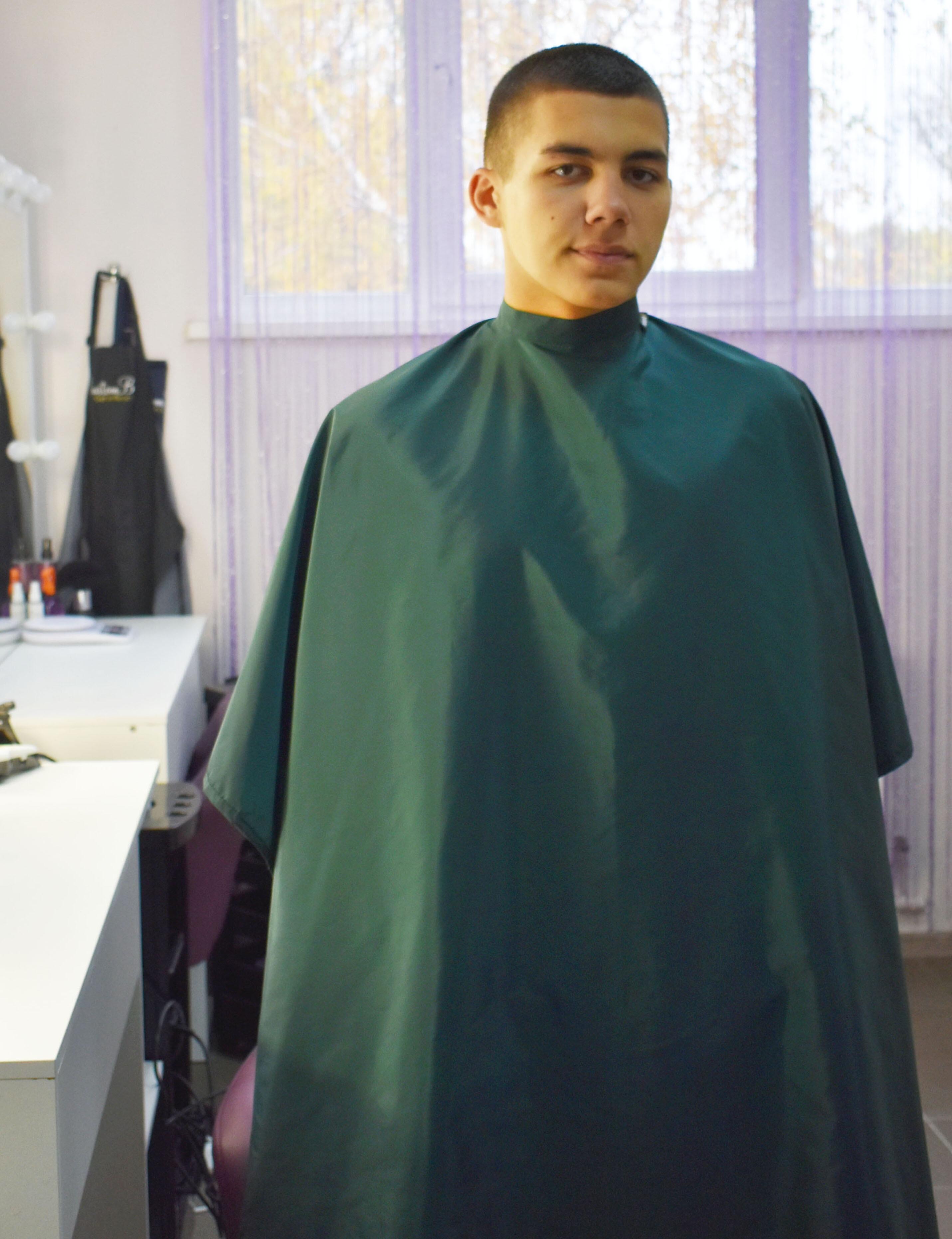 Full-length bottle green barber cape for professional salon and haircutting services