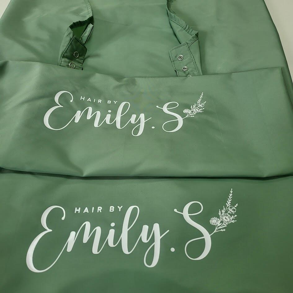 Personalized olive barber cape featuring custom graphic merch prints
