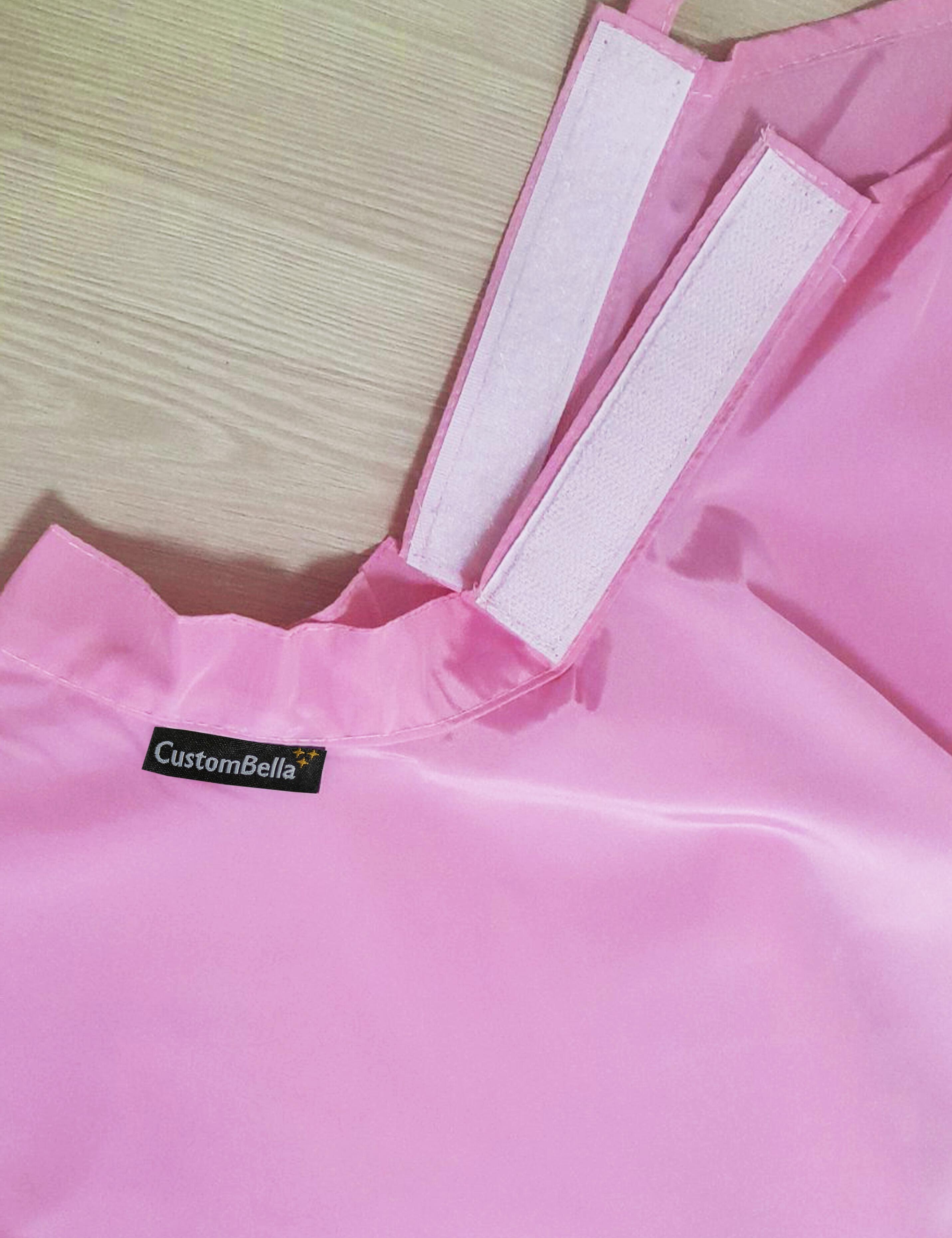 Pink kids salon cape featuring an easily adjustable velcro collar