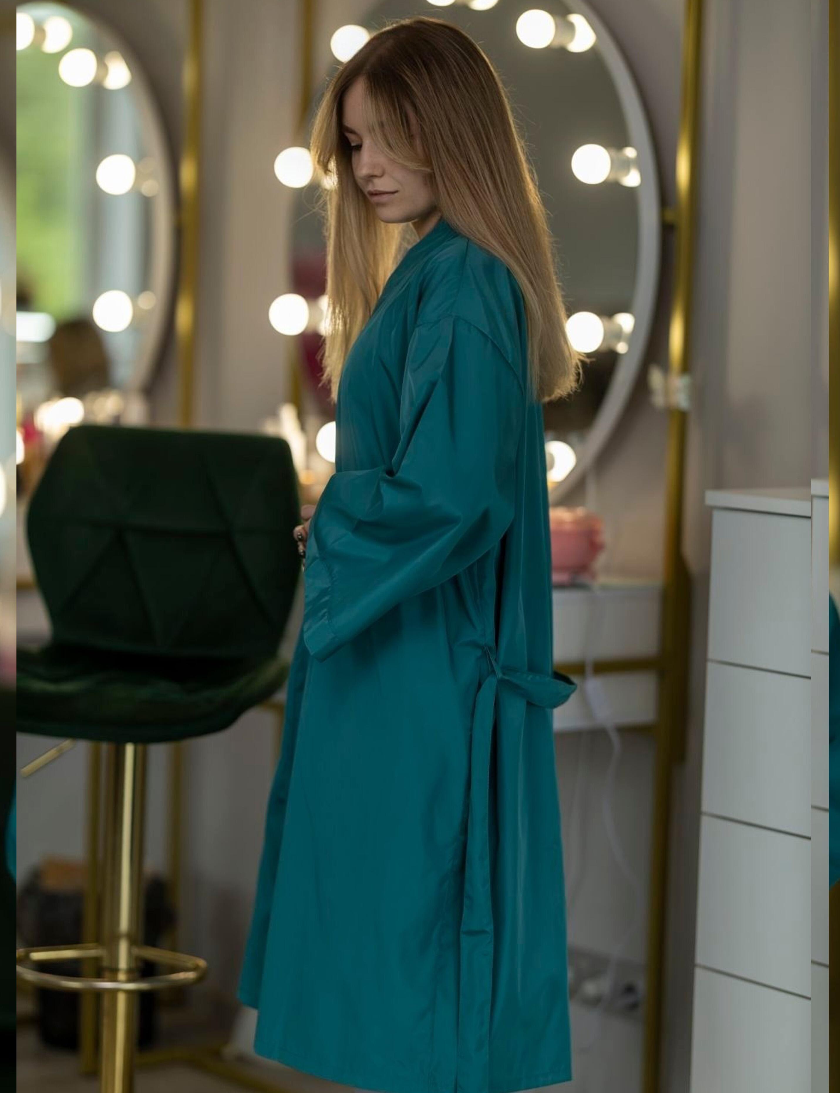 Teal salon uniform apparel personalized with a custom embroidered corporate business logo