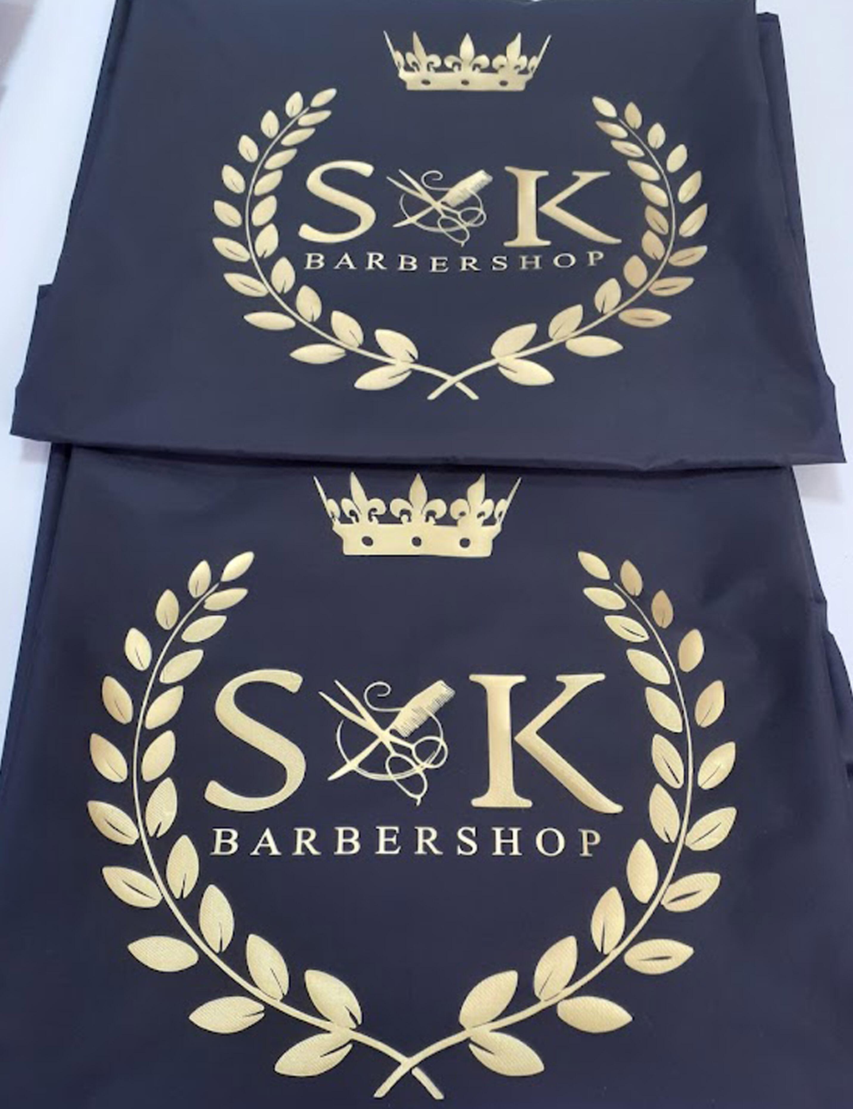 Custom printed black salon cape with personalized hairdresser logo