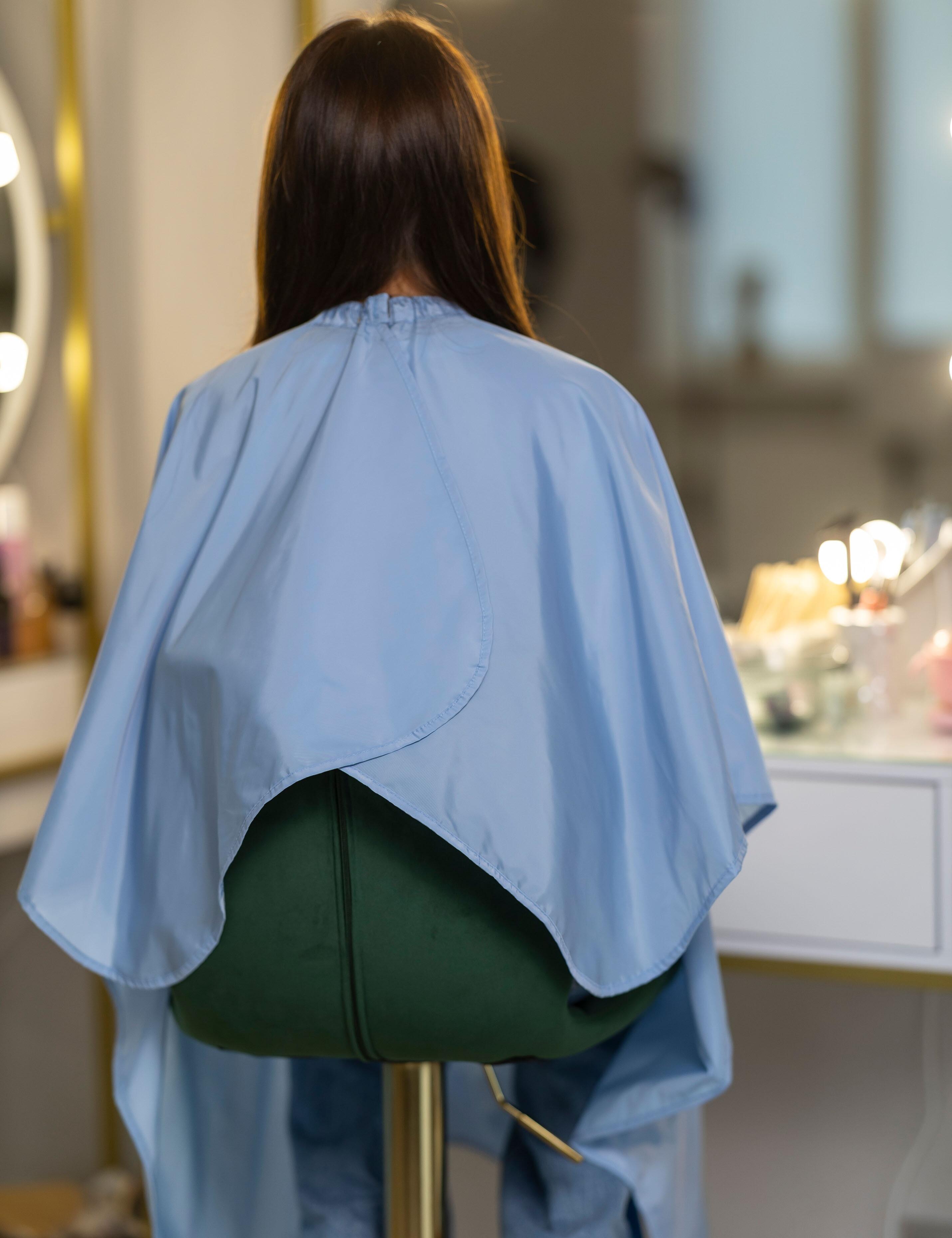 Washable light blue hair cutting cape with arm openings USA