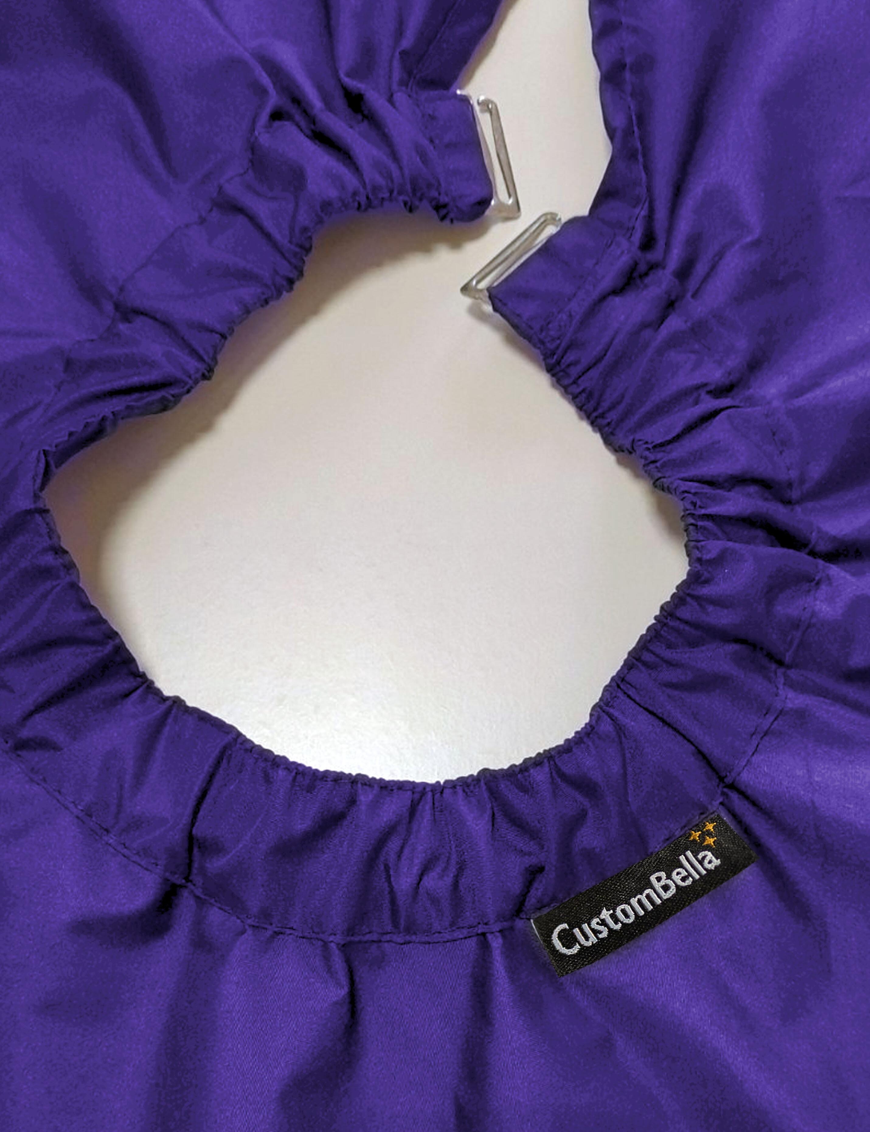 Purple salon cape with hand slits and secure clip closure