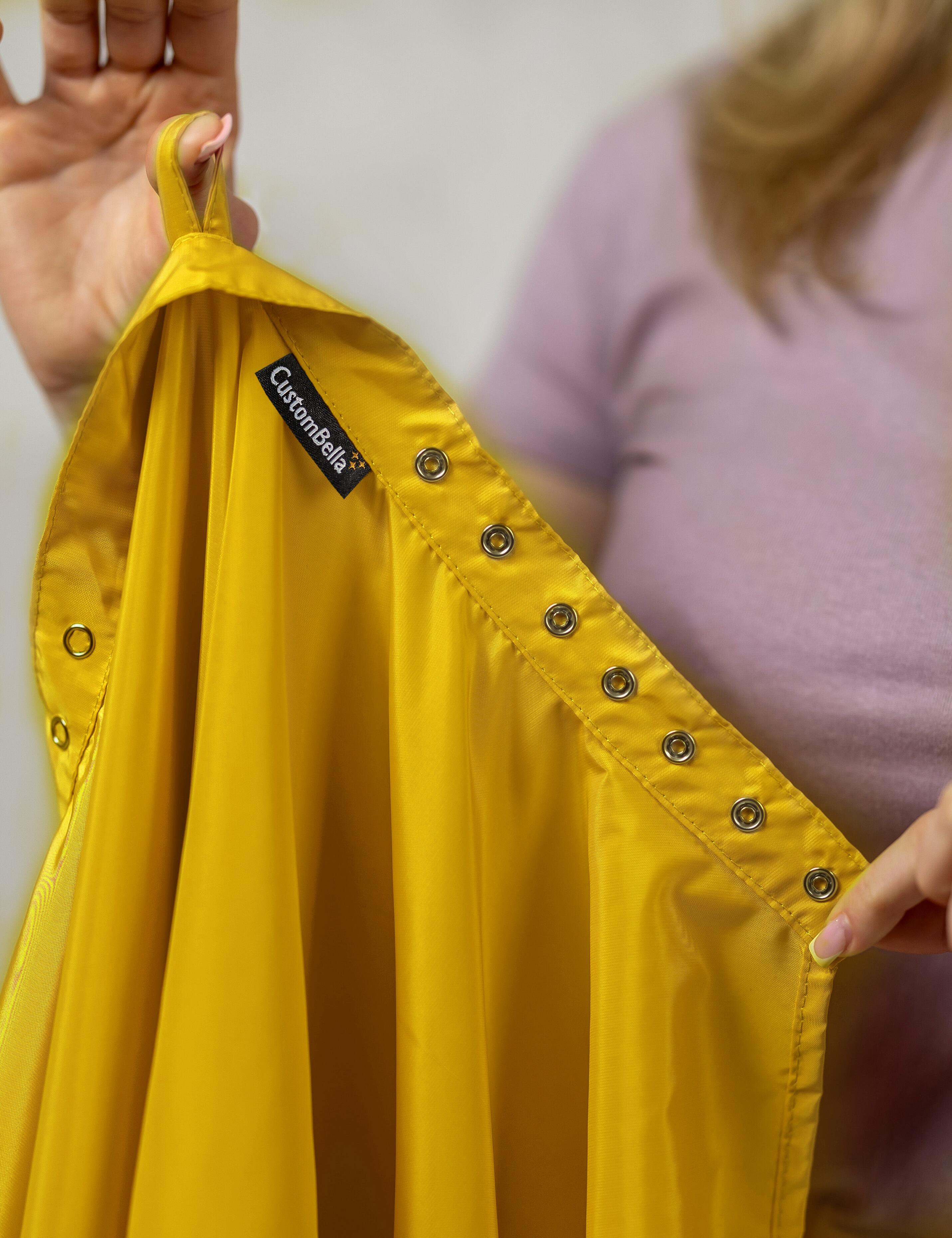 Yellow salon cape with hand slits and adjustable snap closure