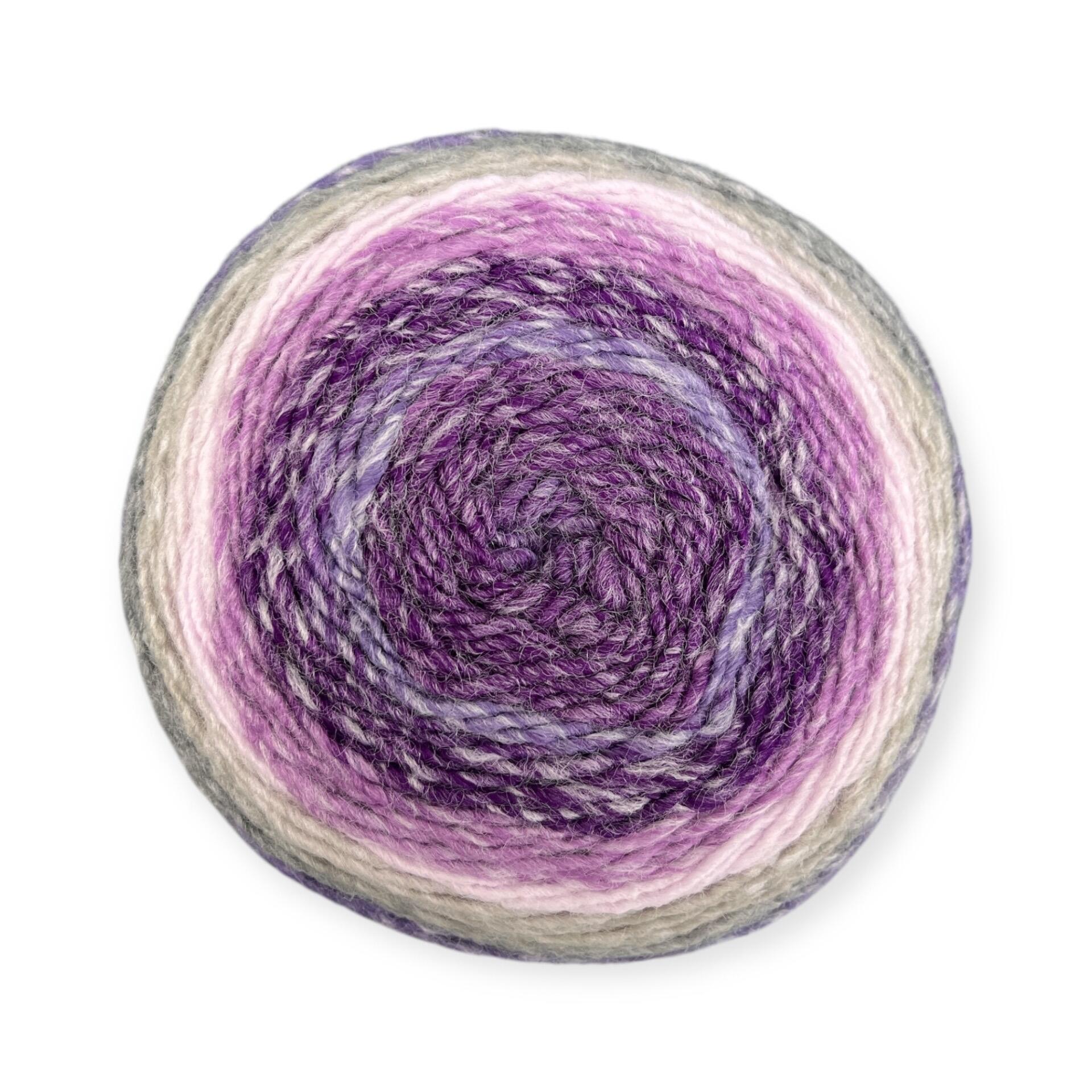 Gradient yarn cake of King Cole Curiosity DK in Heather (2892), showcasing shades of purple, lilac, pink, and grey, ideal for knitting and crochet projects.
