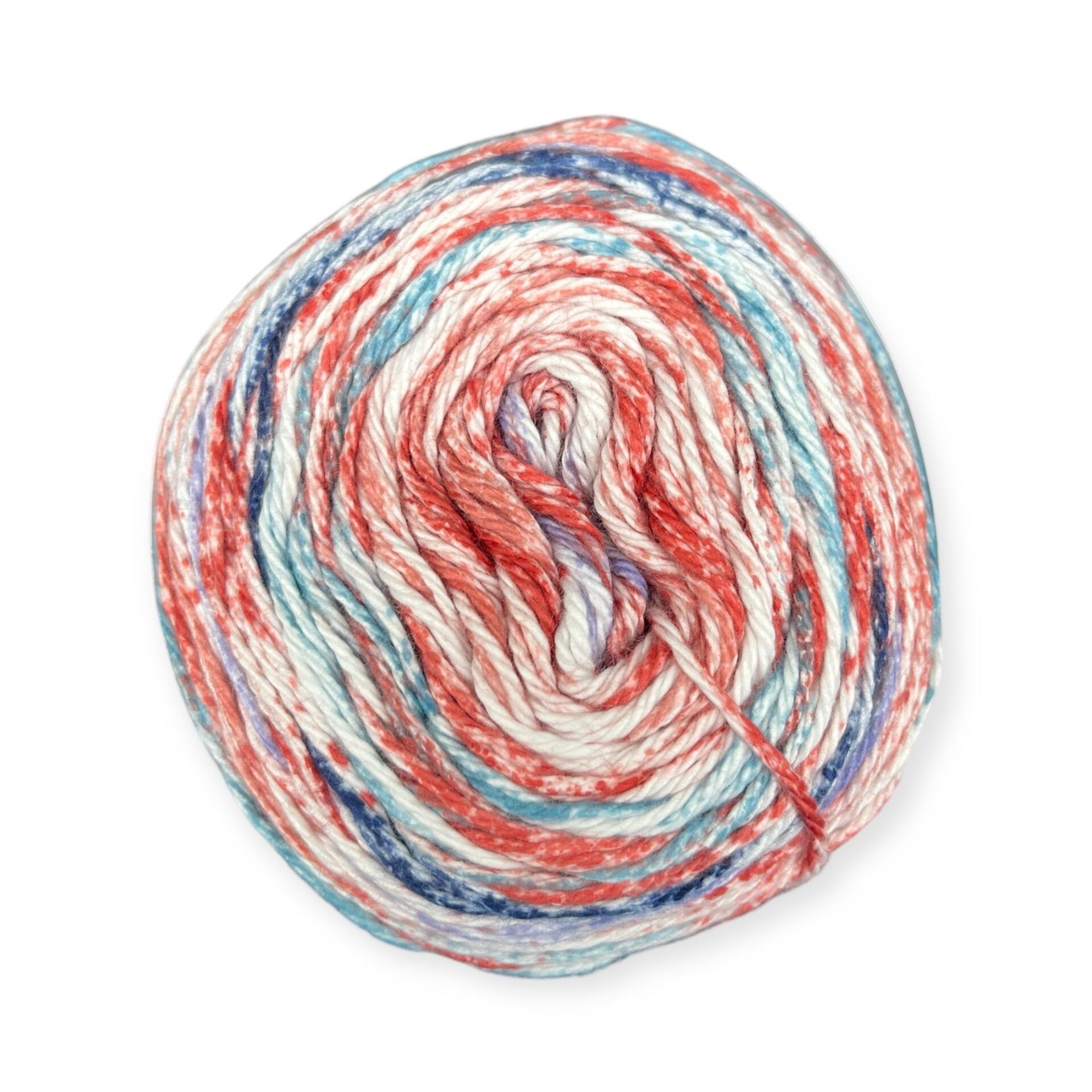 James C. Brett Cotton Waves yarn cake in Tranquil WV02 – 100% cotton DK yarn with blended tones of blue, red, purple, and white.