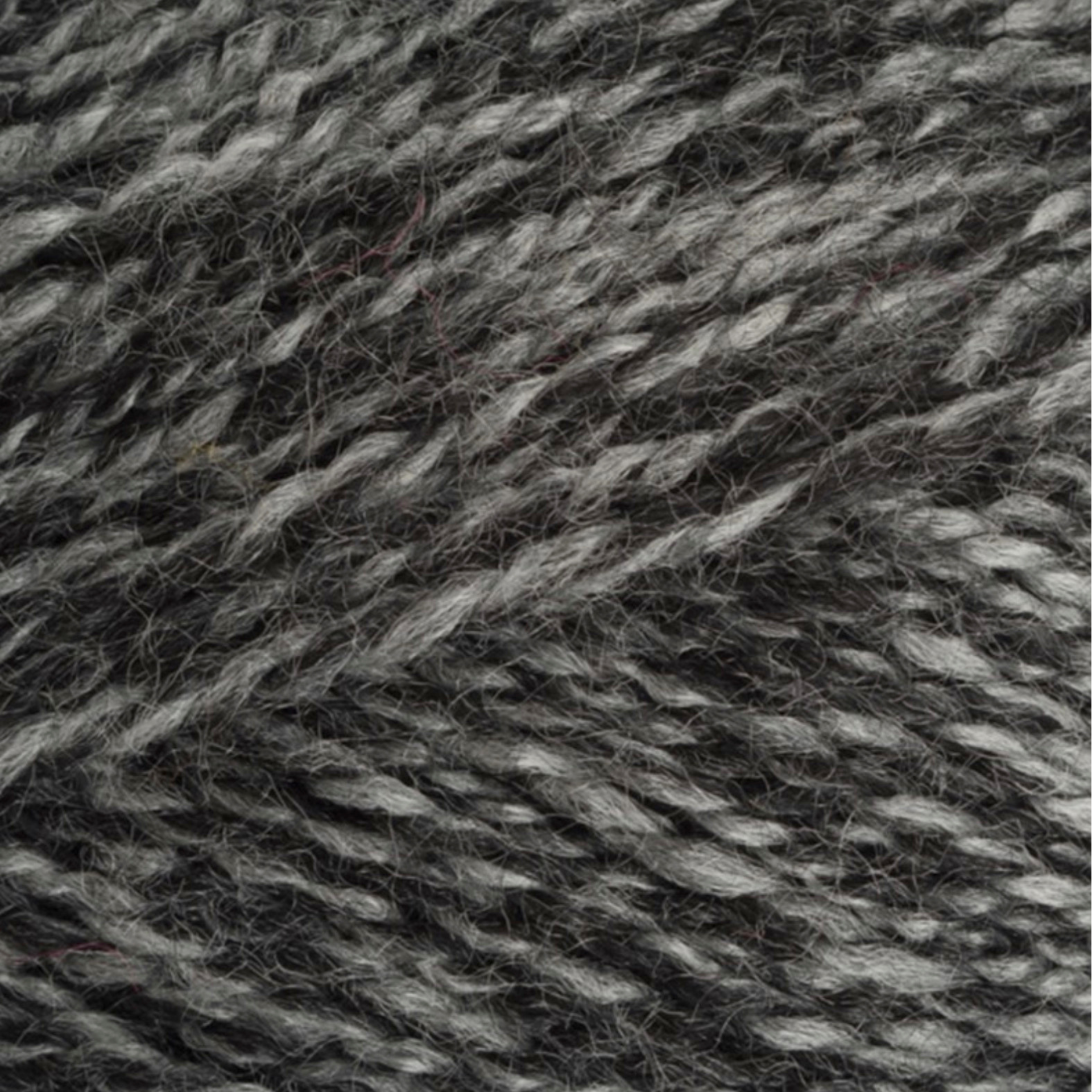 Close-up of StyleCraft Special DK yarn in charcoal shade showing the twist and texture.