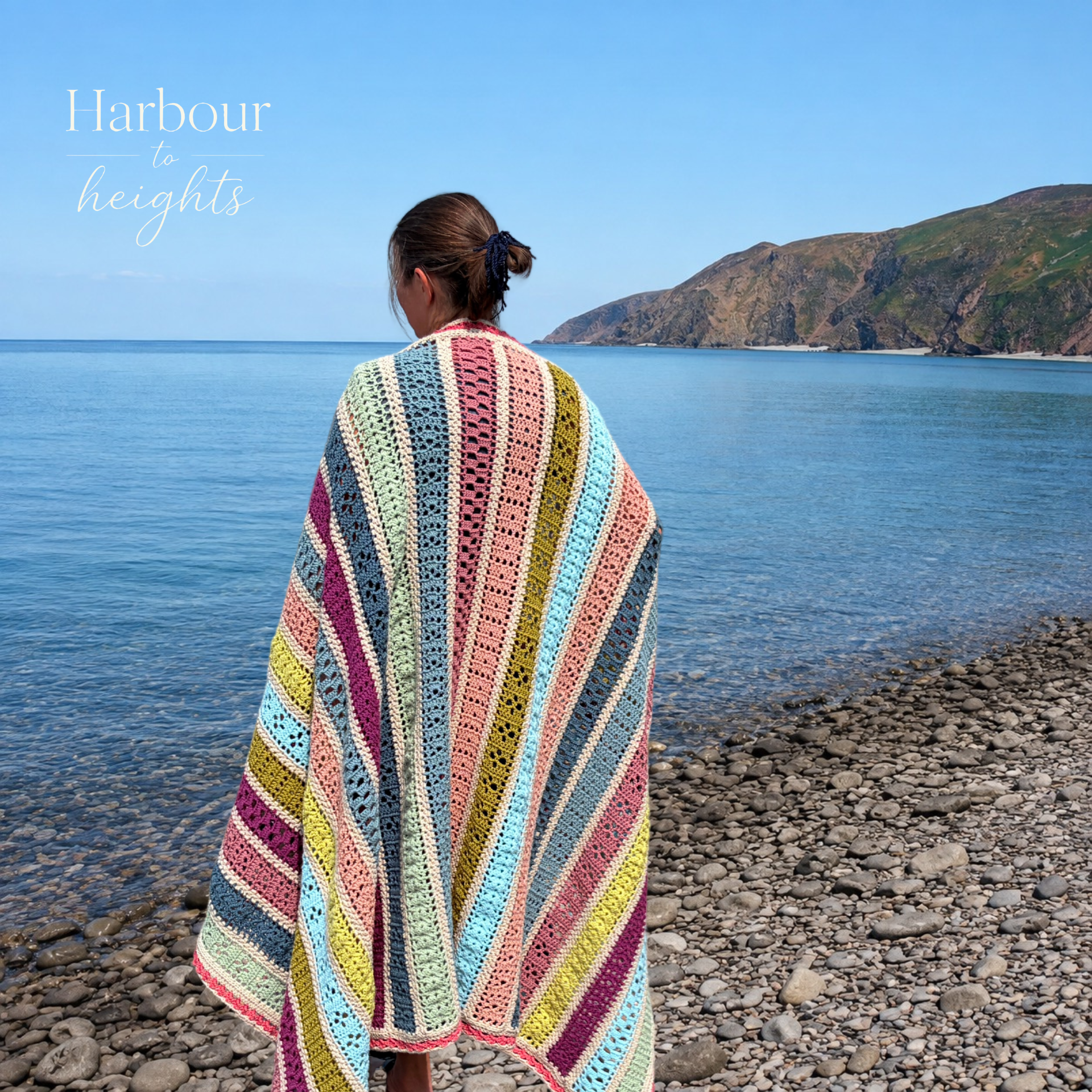 Anja with the Harbour to heights blanket over her shoulders looking out to the sea