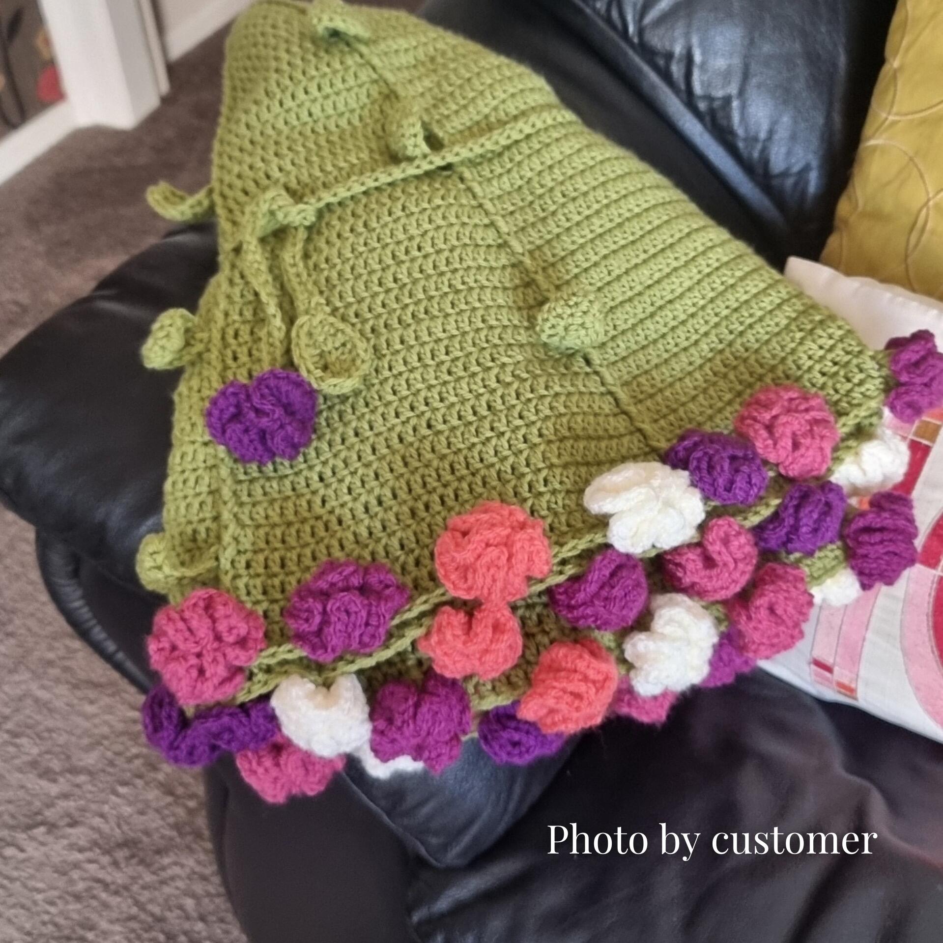 Customer photo of finished Bouquet Blanket – folded crochet blanket with floral edging along the border.