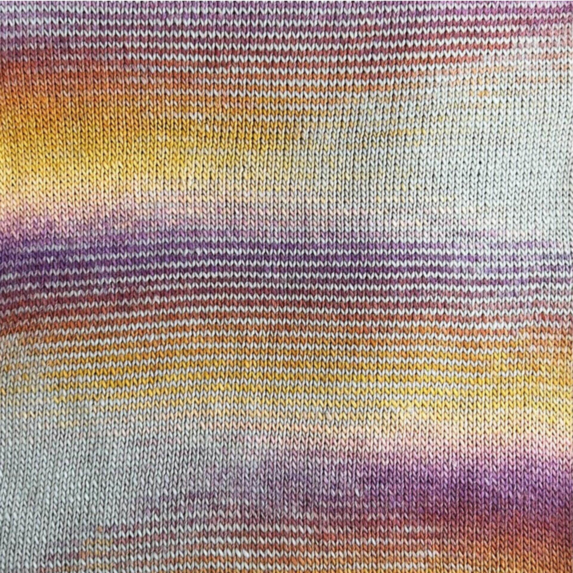Knitted swatch of Stylecraft Knit Me Crochet Me Solar Flare yarn – self-striping DK with orange, gold, lilac and neutral colour transitions
