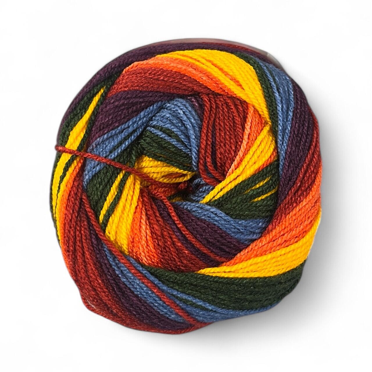 James C. Brett Swurlywurly DK yarn cake in Autumn Notes (SRL10), featuring rich swirls of gold, rust, burgundy, forest green, and denim blue – soft self-striping acrylic DK yarn for crochet and knitting projects.