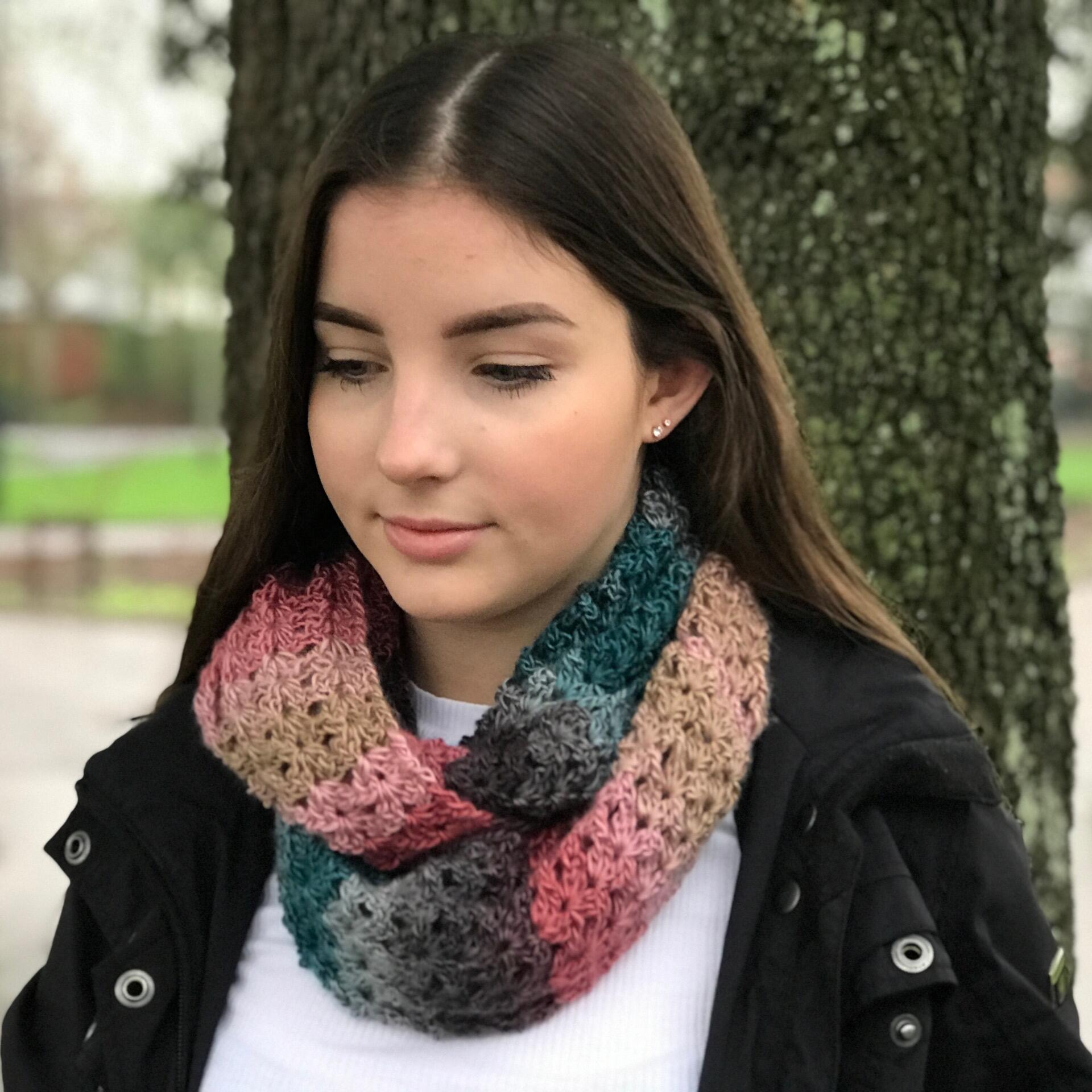 Rachel Scarf crochet pattern worn as an infinity scarf, featuring a textured shell stitch design using colour-changing DK yarn