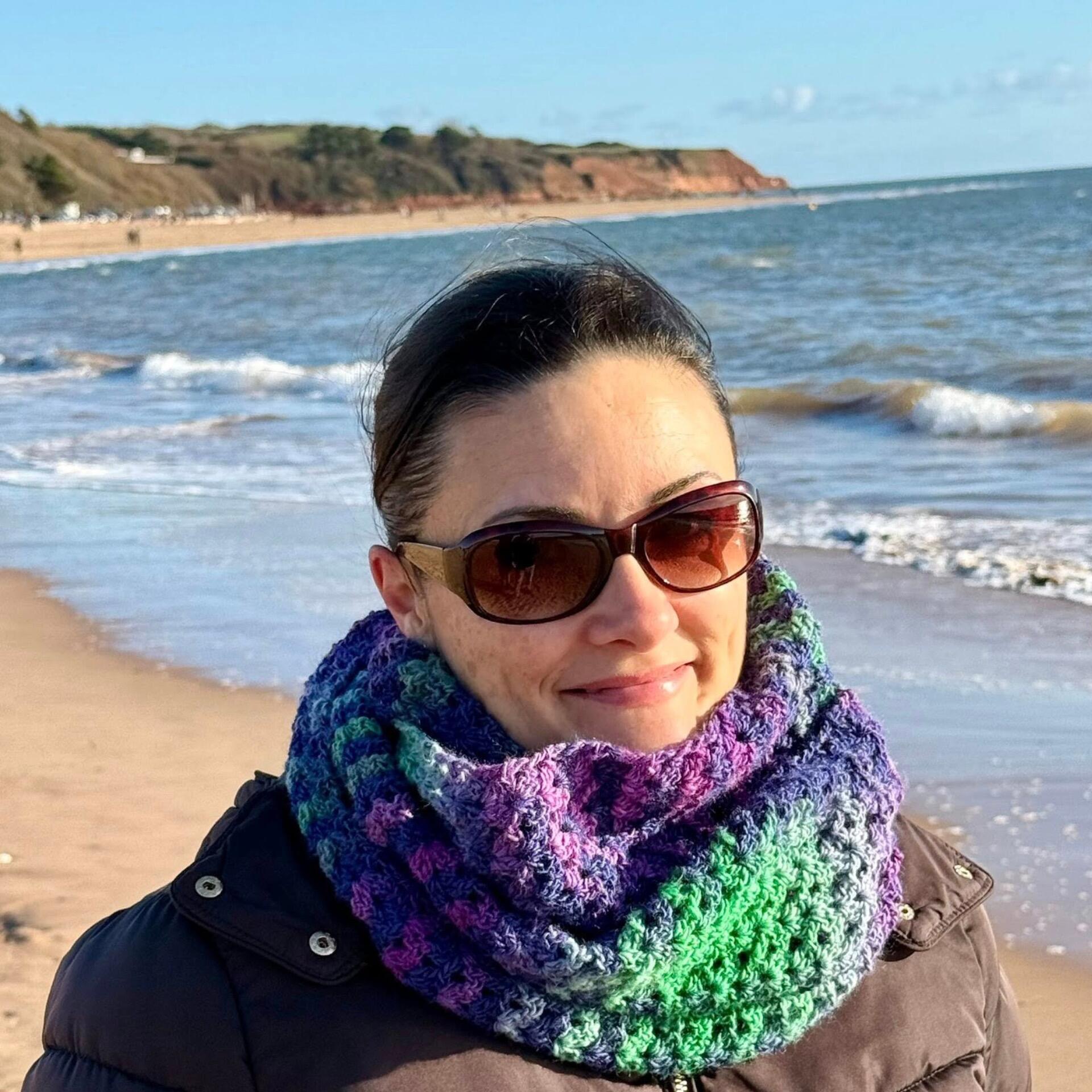 Woman wearing the Rachel Scarf crochet loop scarf made with DK gradient yarn, showing textured shell stitch pattern by Ophelia Talks Crochet