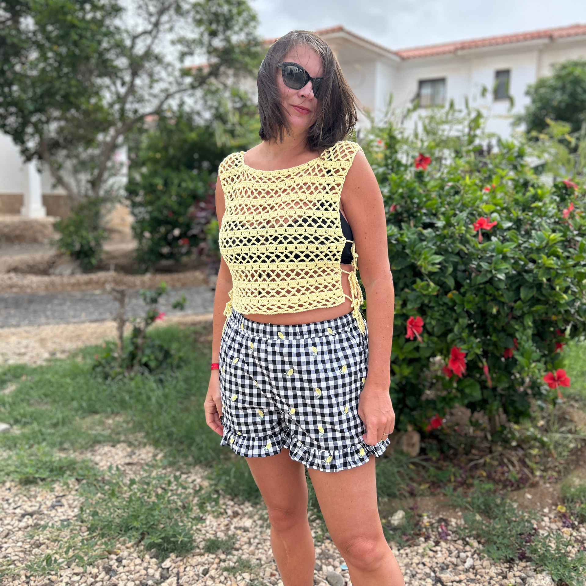 Lacy yellow crochet mesh summer top worn with gingham shorts
