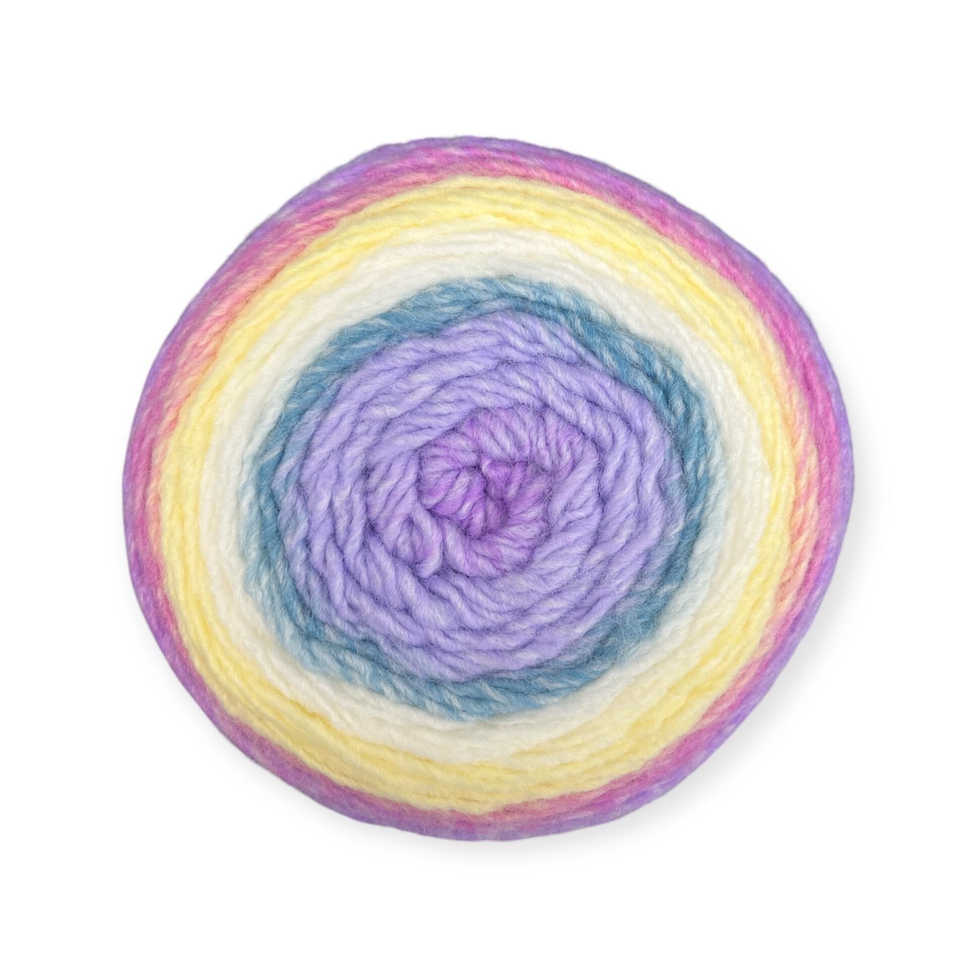 Gradient yarn cake of King Cole Curiosity DK in Mirage (6331), featuring soft pastel shades of lilac, yellow, pink, and blue—ideal for whimsical knitting and crochet projects.