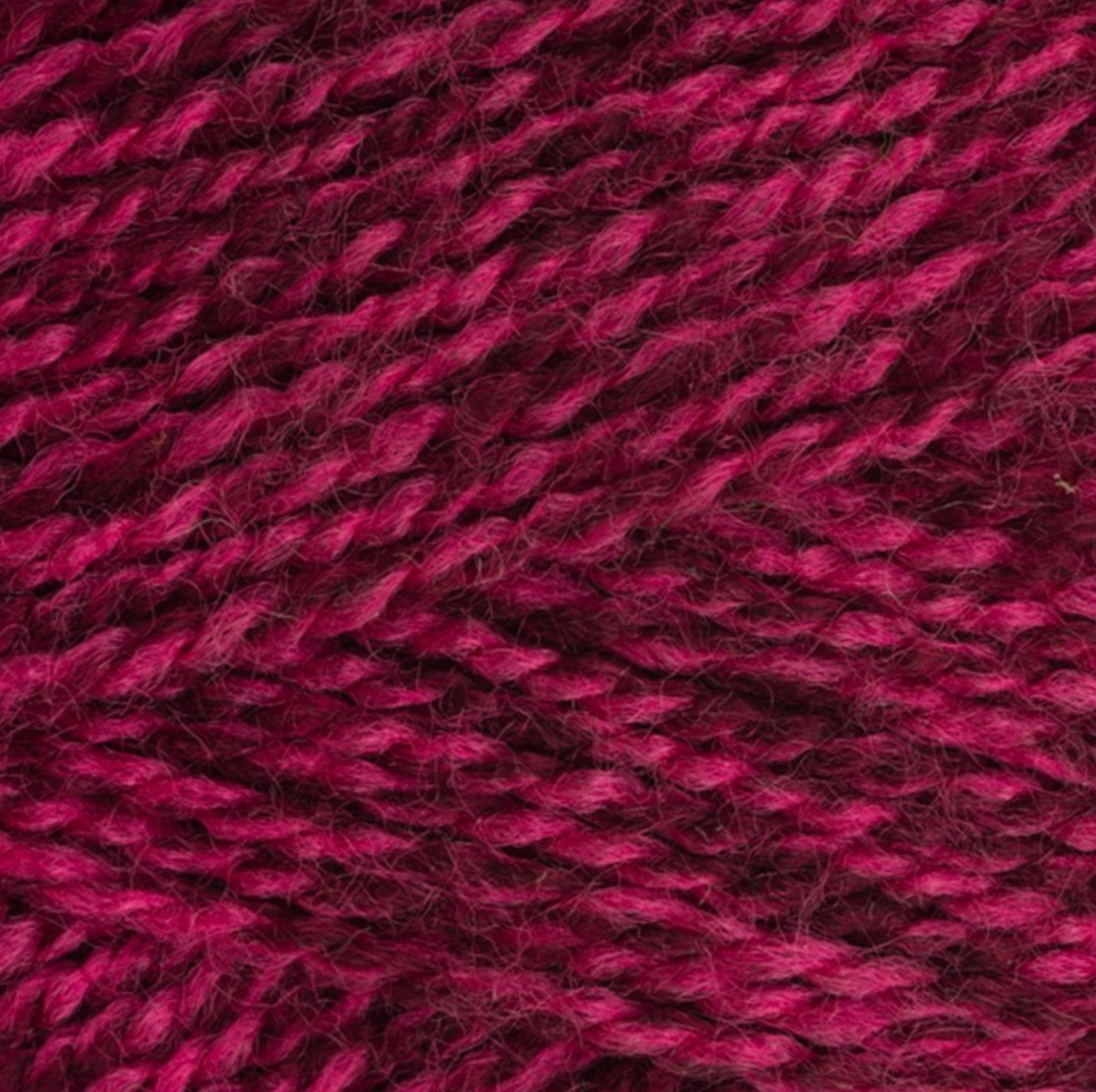 Close-up of StyleCraft Special DK yarn in peony shade showing the twist and texture.