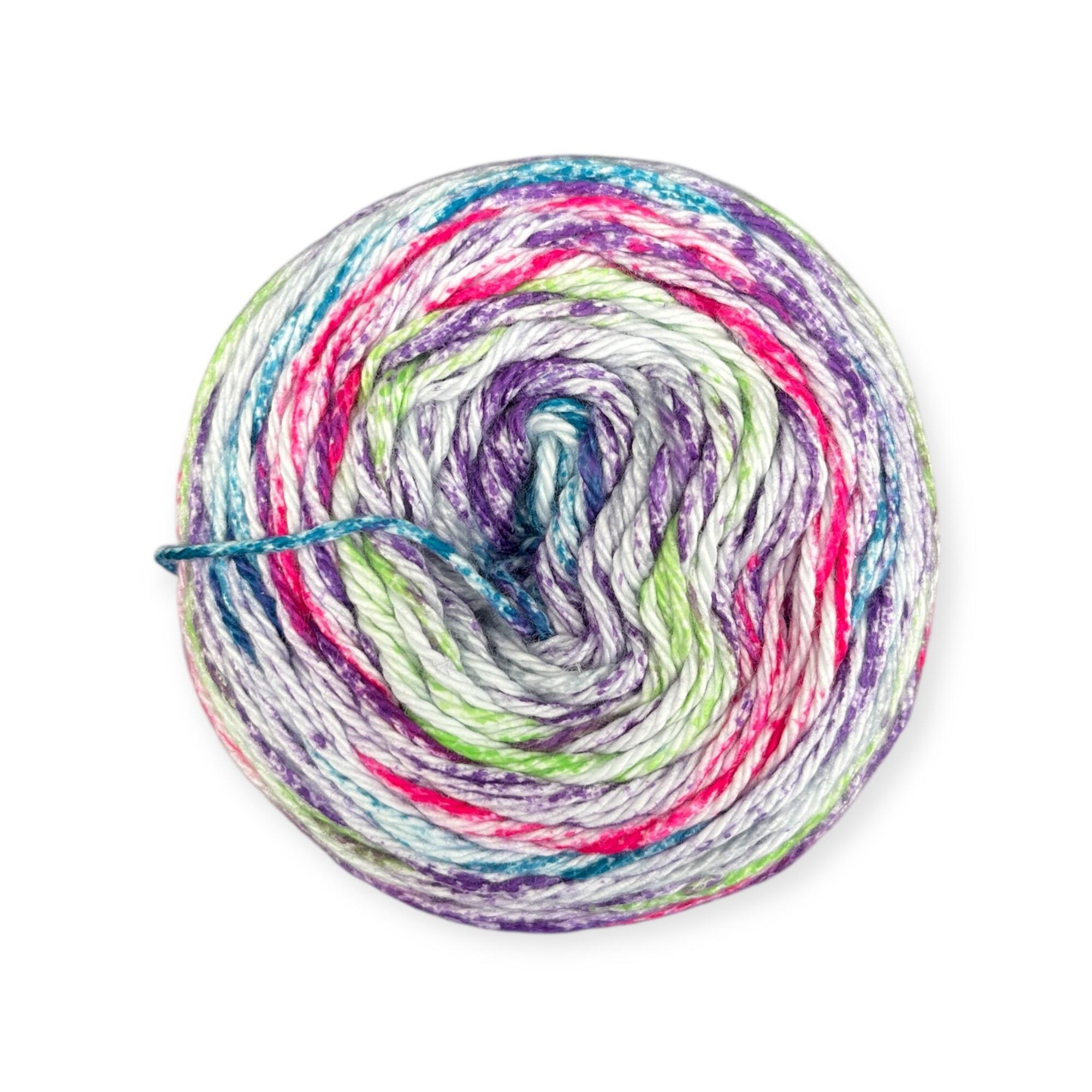 James C. Brett Cotton Waves yarn cake in Fruit Jelly WV04 – 100% cotton DK yarn featuring blue, green, purple, pink, and white tones.