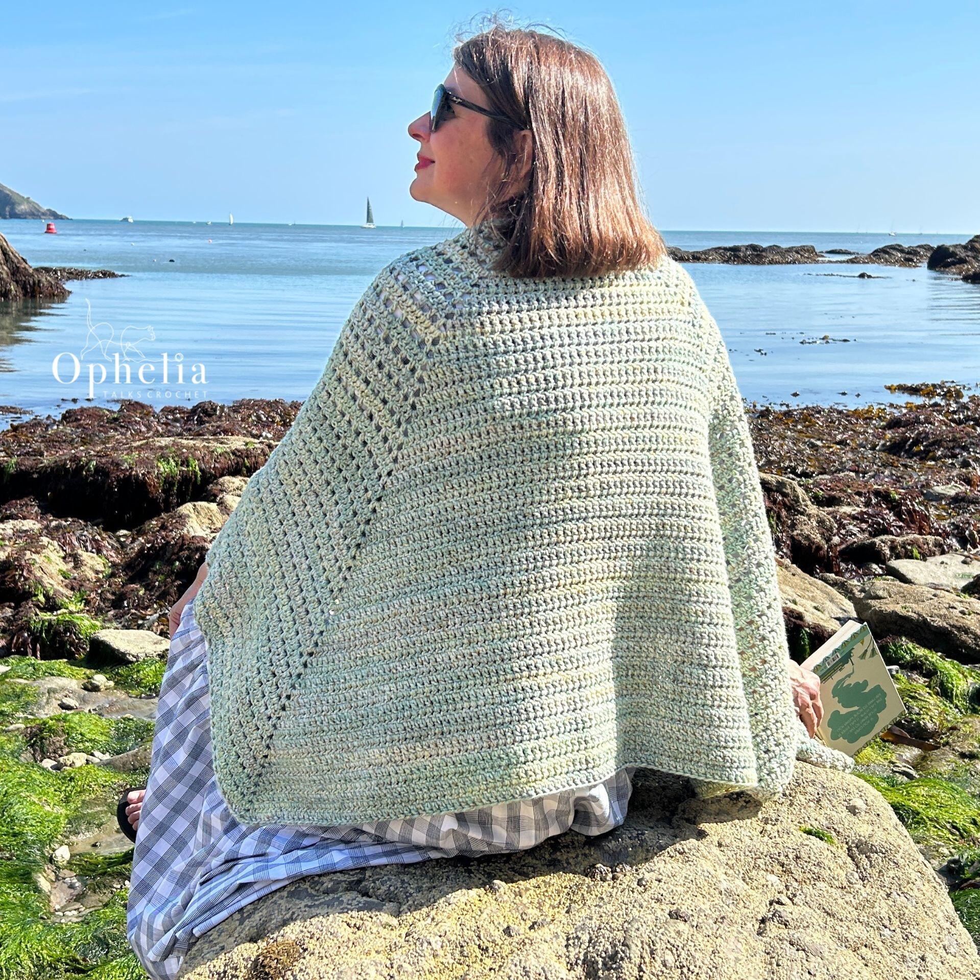 Anja wearing her reading shawl whilst reading and looking out at sea