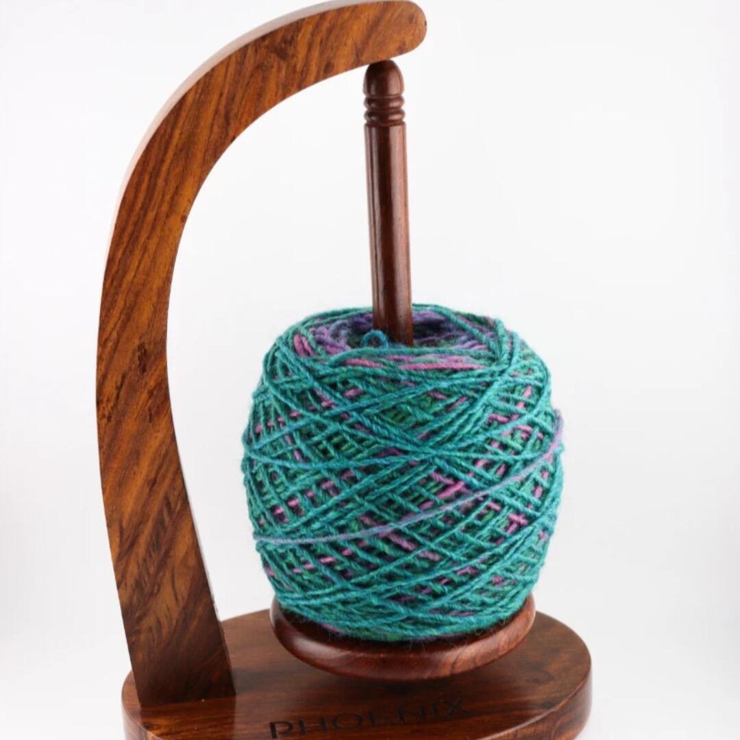 Hand crafted Sheesam wood yarn concierge or yarn holder for holding a ball of yarn to easily unwind for a smooth yarn supply