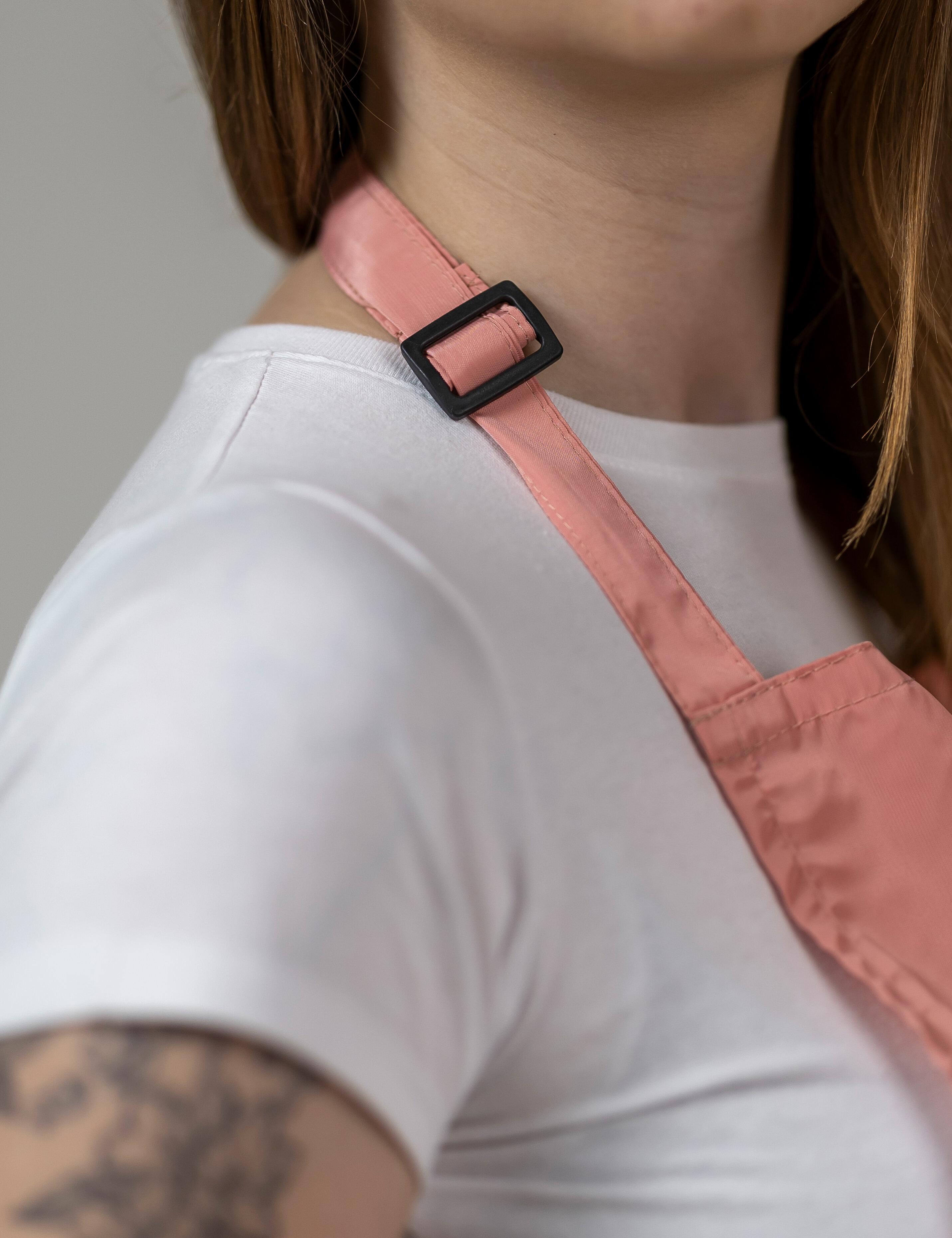 Beauty master wearing plain peach waterproof salon apron