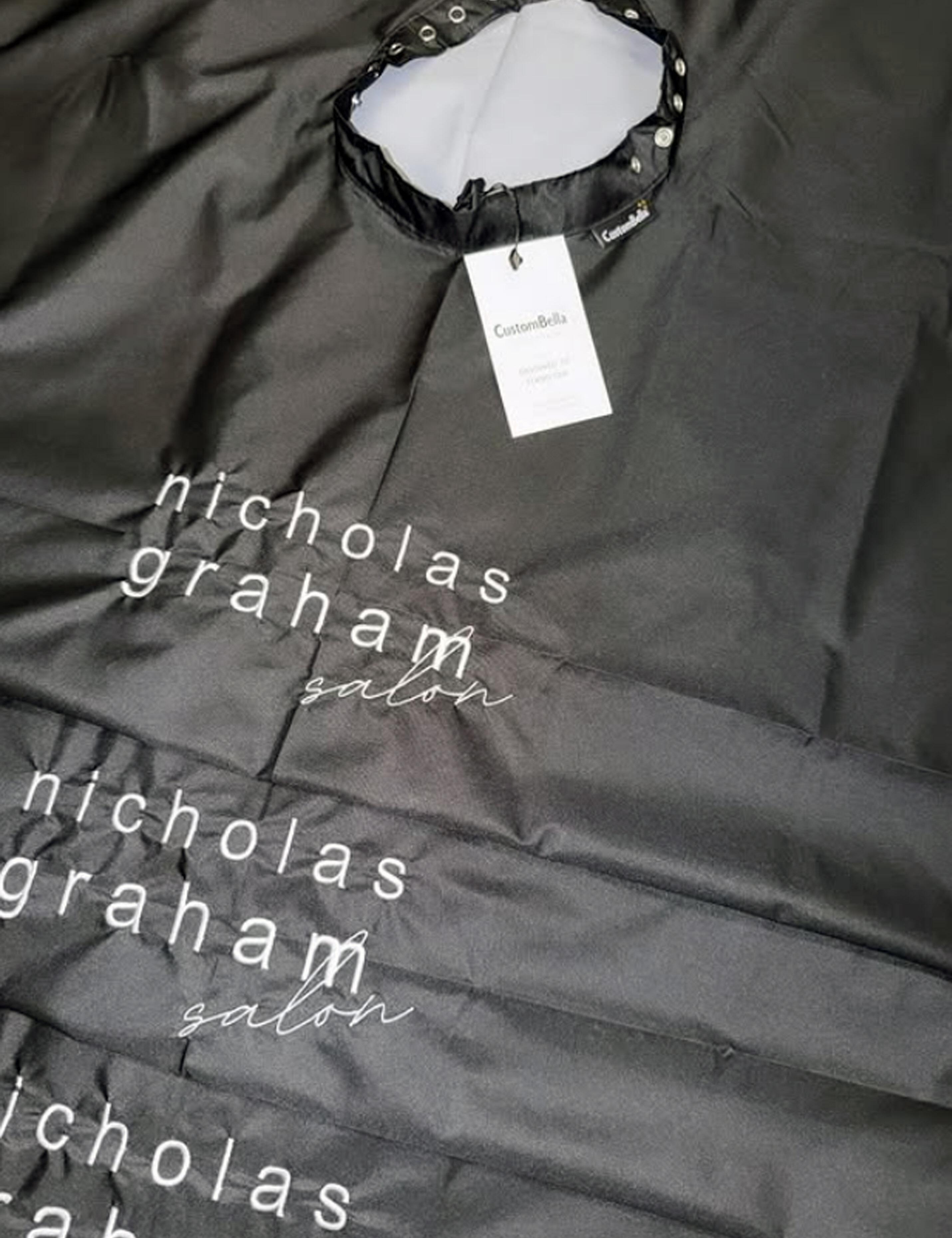 Premium black salon cape with custom embroidered logo