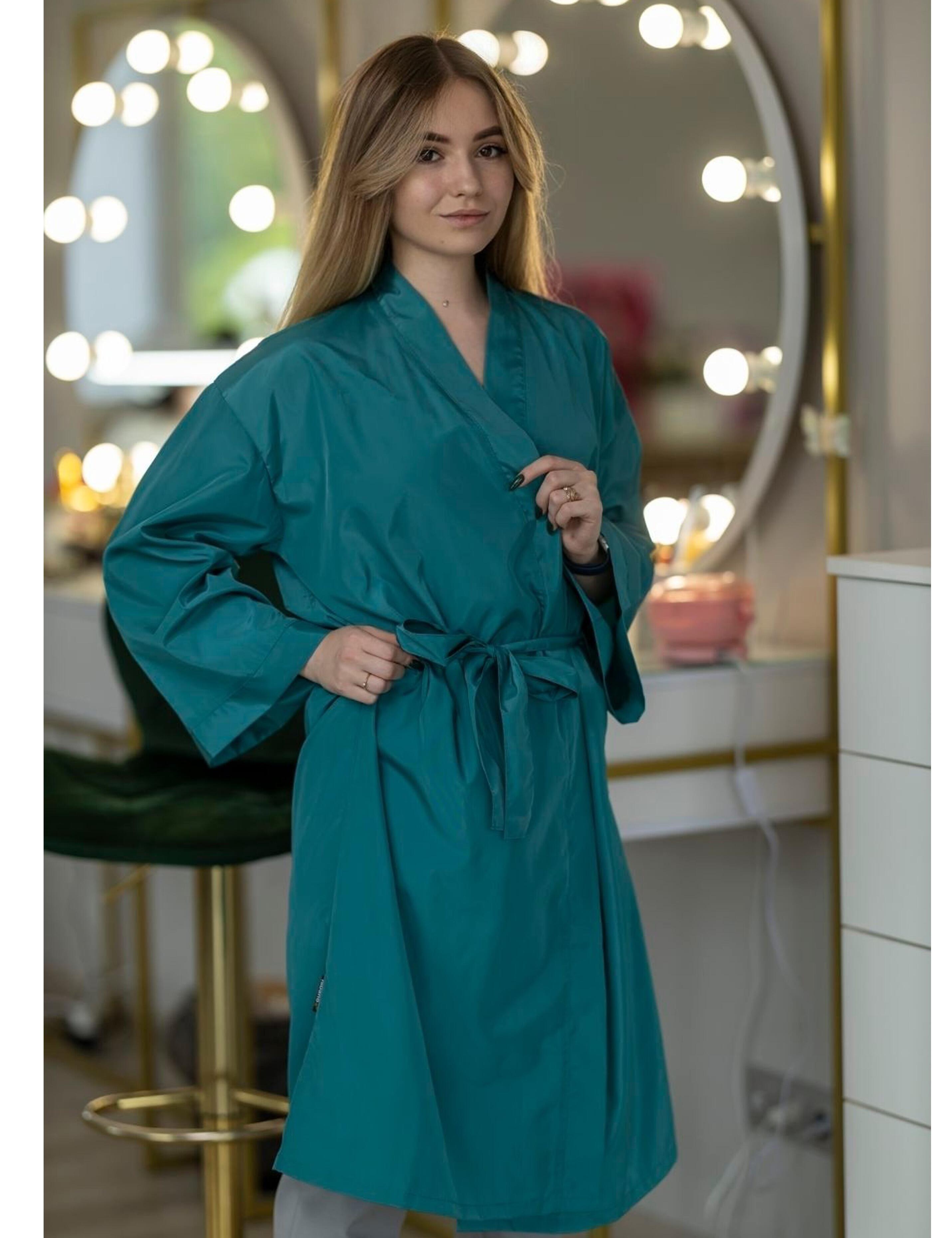 Teal salon uniform apparel personalized with a custom embroidered UK business logo