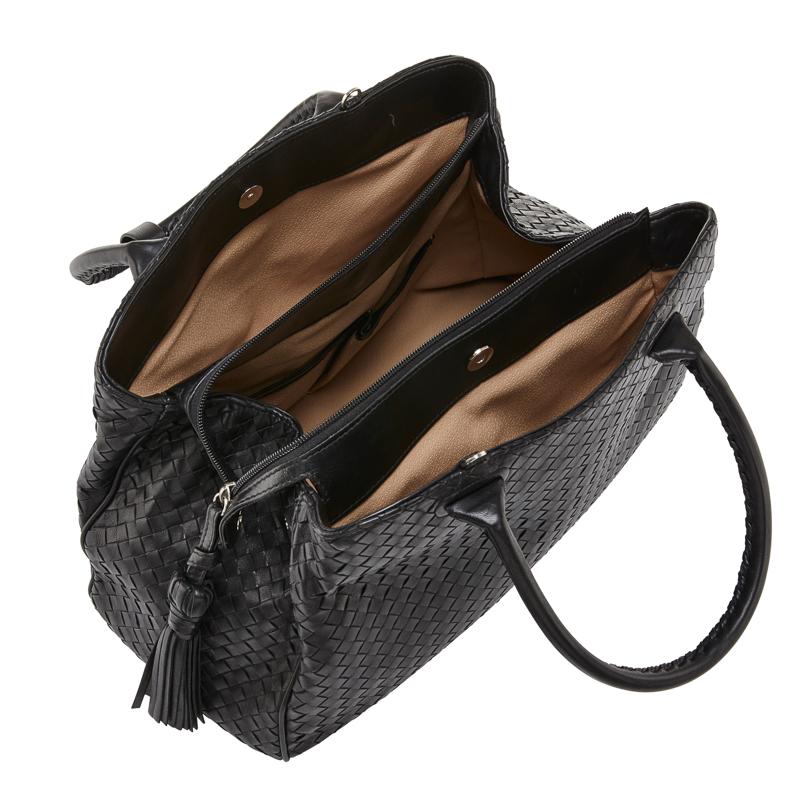 Exquisite woven leather handbag in black with double handle and pull tassel, open view.