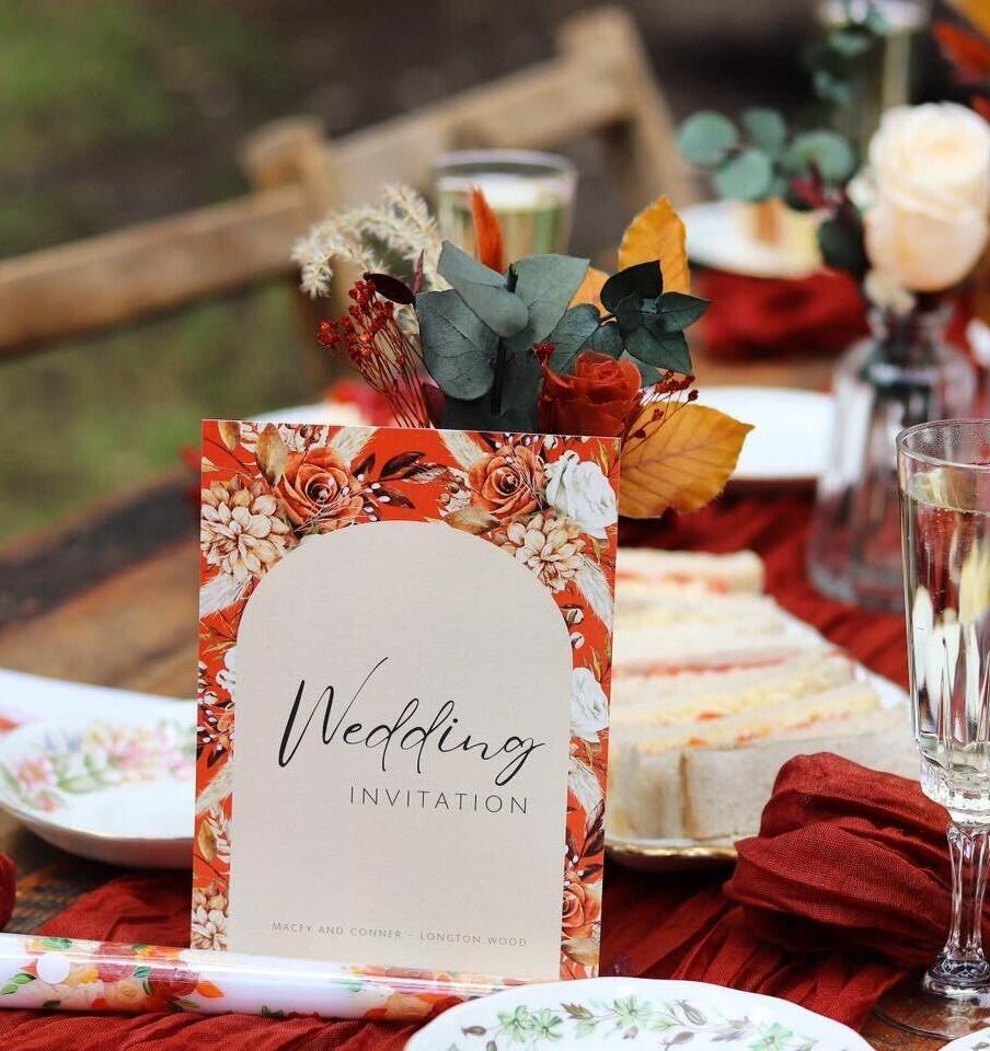 Rustic autumn wedding invitation suite in real life at a woodland wedding table set up