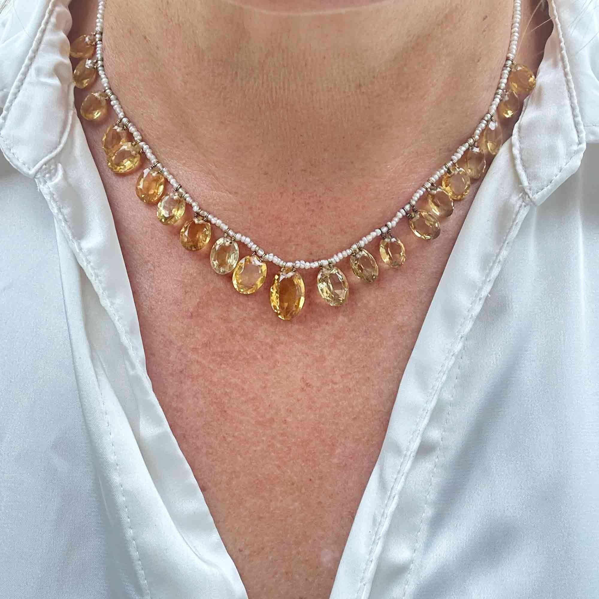 Full view of Edwardian citrine and pearl fringe necklace with 9ct gold chain, circa 1901, worn on models neck.