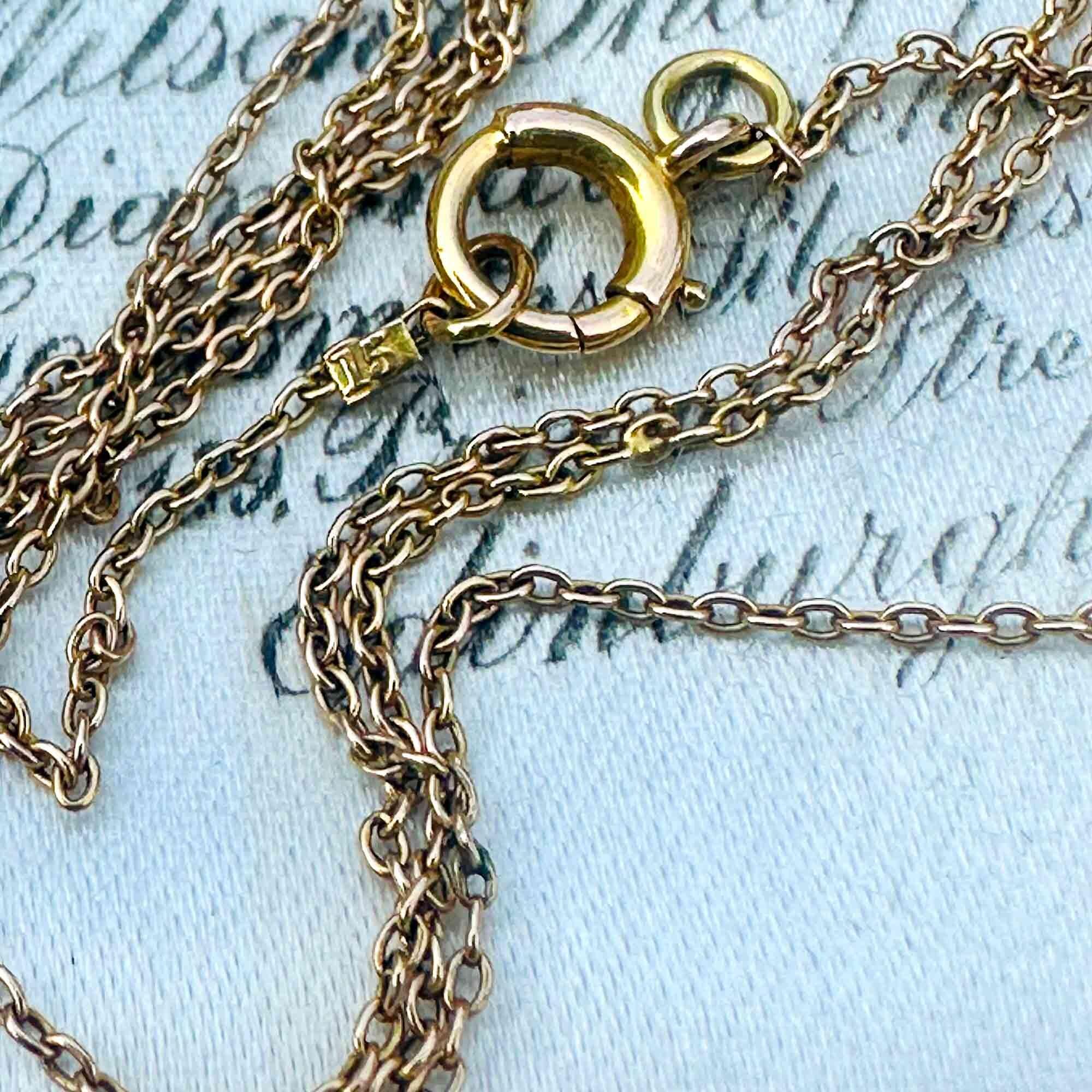 Close-up of rare antique Edwardian 15k gold rolo link chain on white background