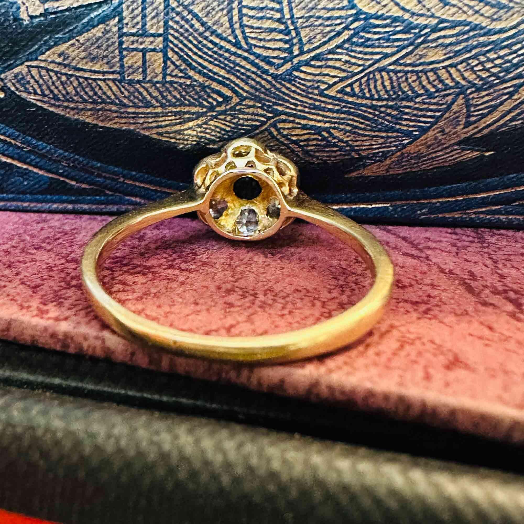 Rear view, Art Deco 18k gold Sapphire and diamond cluster daisy ring on antique boxes.
