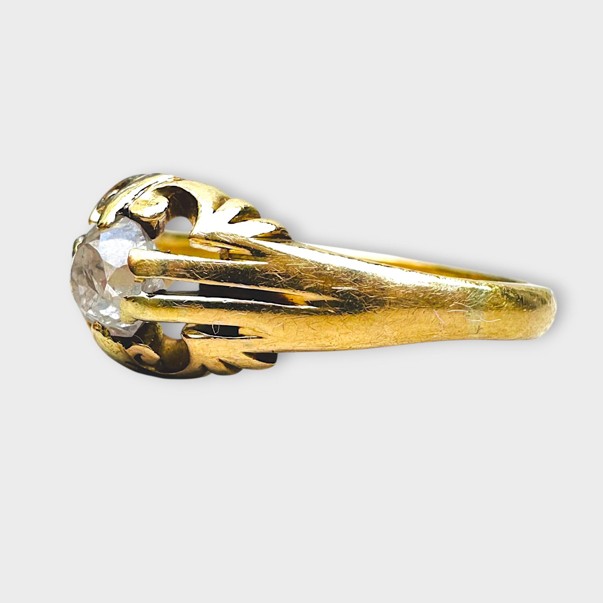 Side view, Antique 18k yellow gold old cut diamond gypsy ring on grey background.