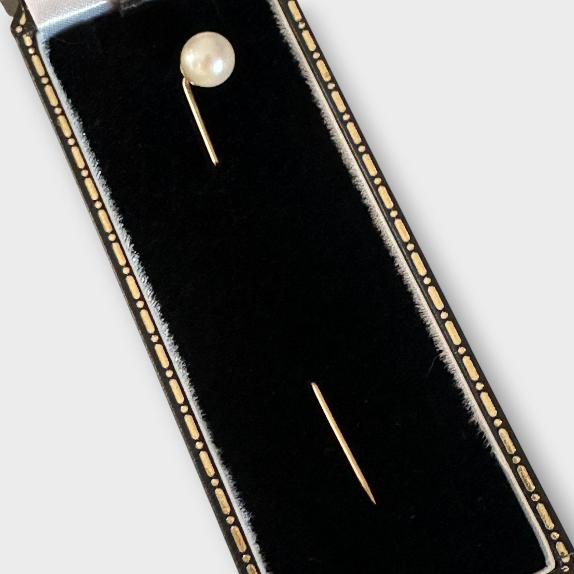 Late Art Deco 9ct gold 7mm Cultured Saltwater pearl stick pin in black velvet box on grey background.
