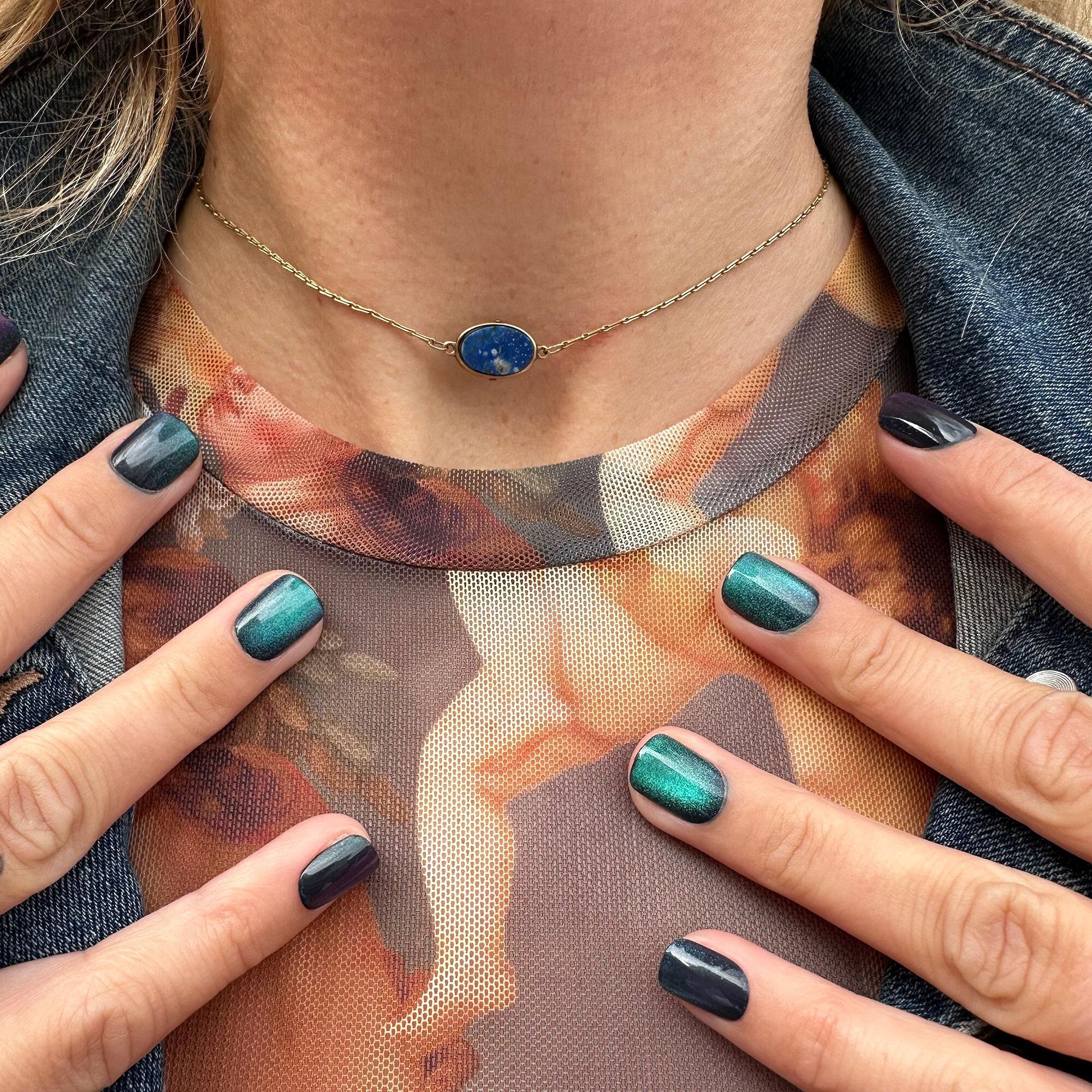 Vintage 9k gold lapis lazuli pendant necklace on model.