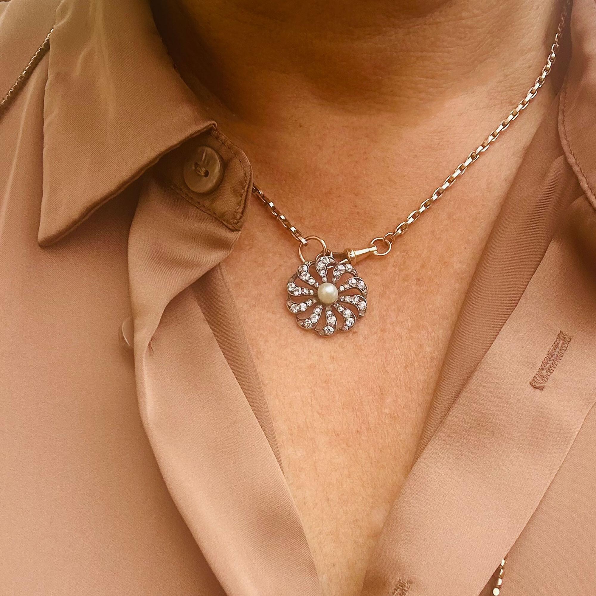 antique diamond and pearl celestial sunburst pendant on models neck