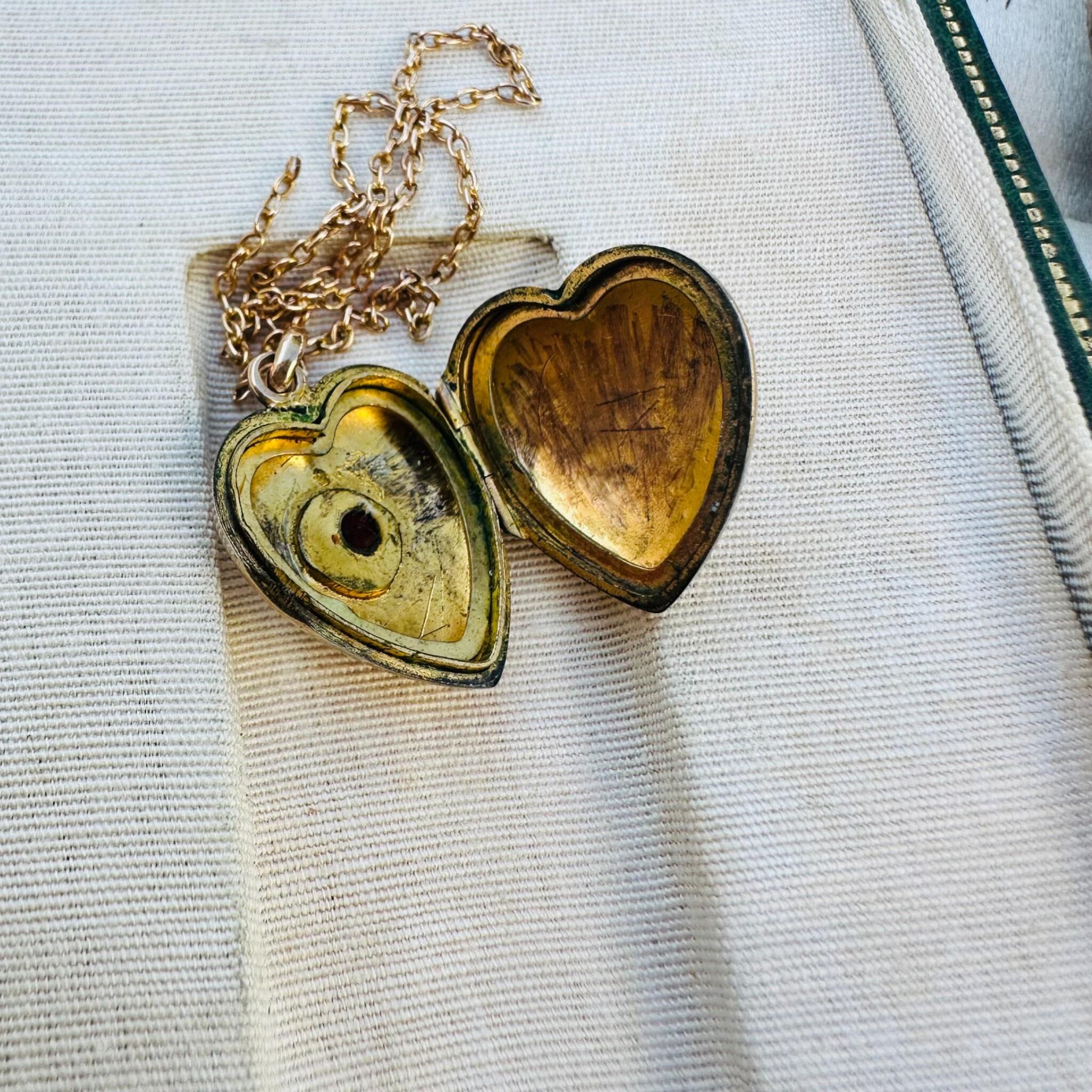 Victorian Gold Heart Locket Pendant with Garnet Star-Set Detail, open and displayed in antique box.