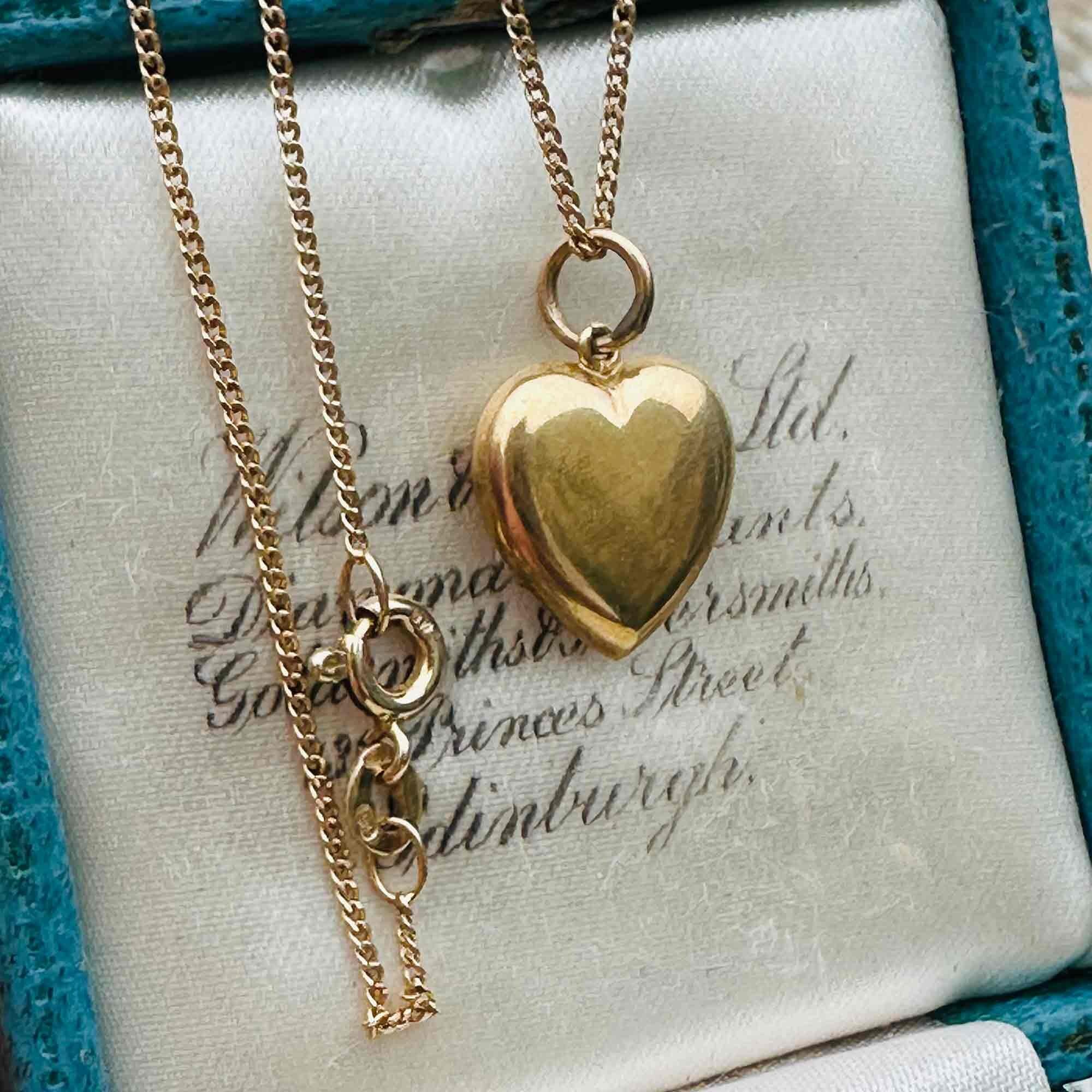 Gold Puffy Heart Necklace with Chain Dating 1942, displayed in a antique box.