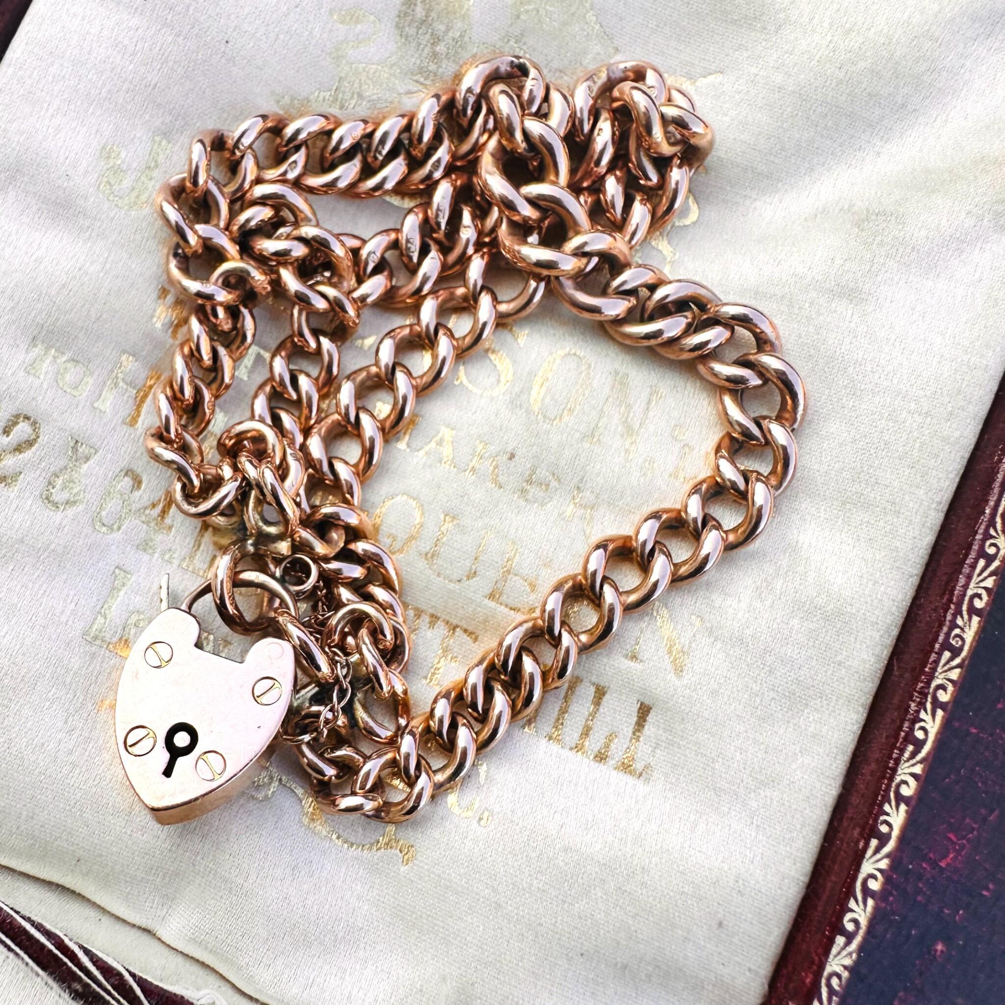 Rose Gold Double Curb Link Bracelet with Heart Padlock , displayed on antique box.