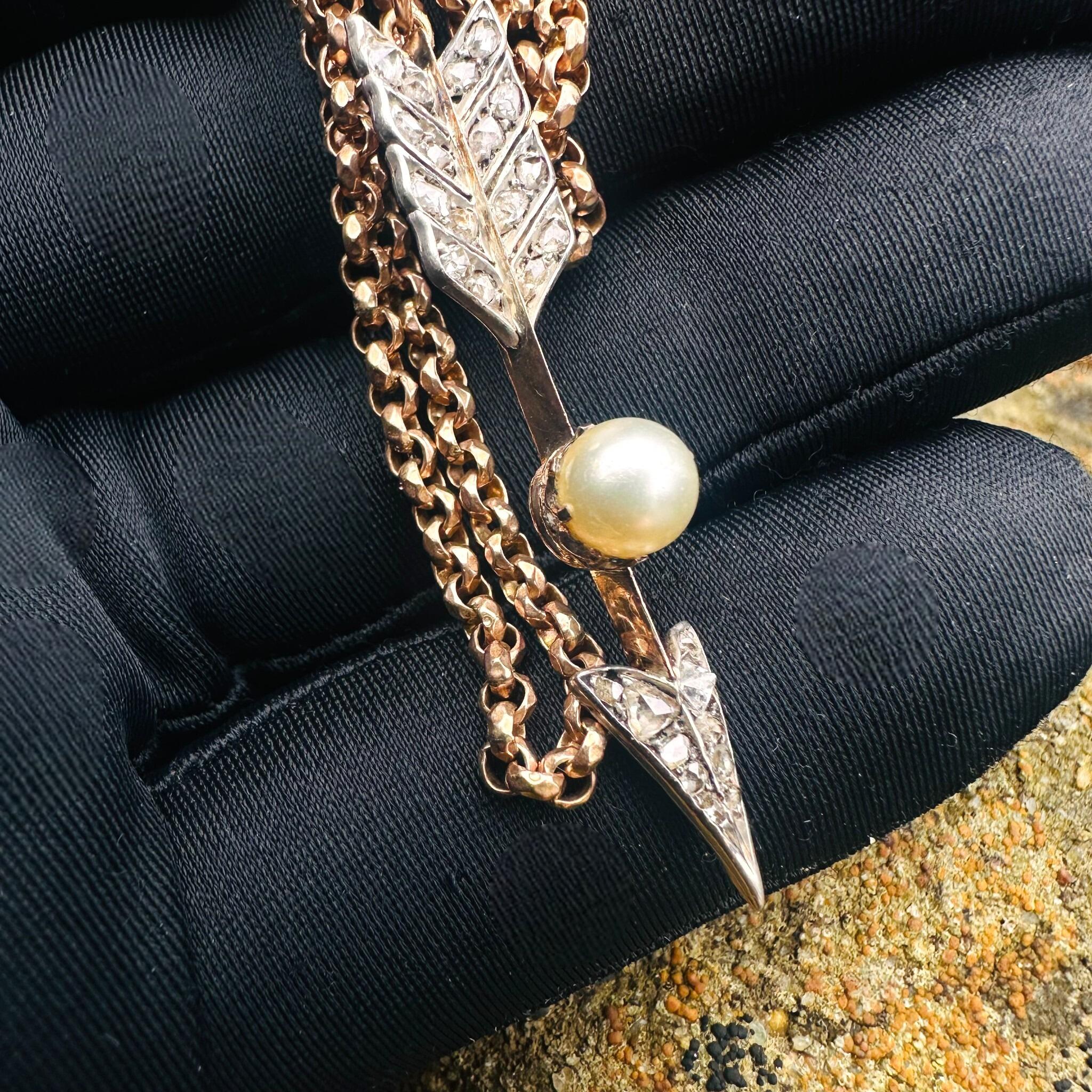 Victorian Rose Cut Diamond & Pearl Cupid’s Arrow Pendant held in gloved hand