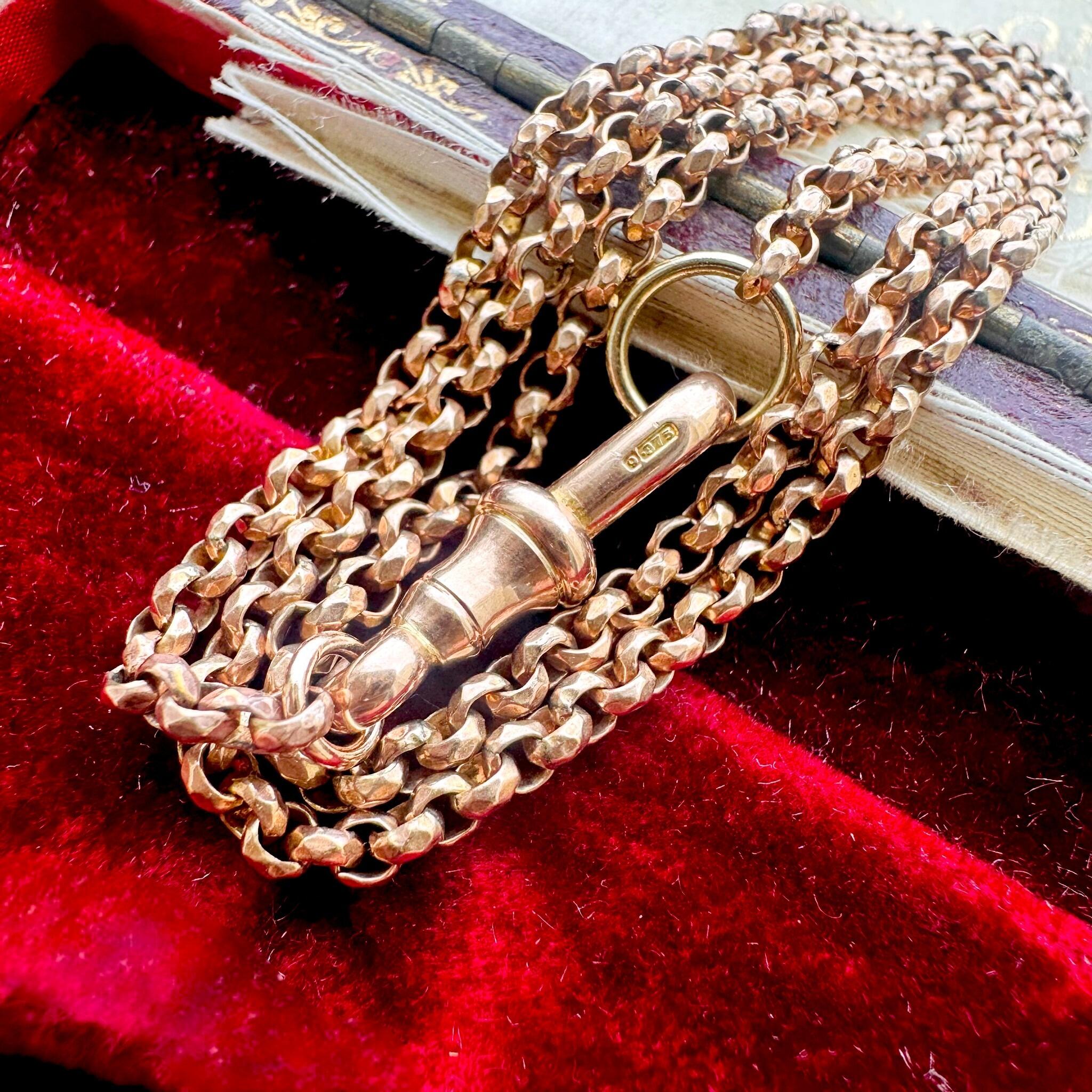 Rose Gold Faceted Belcher Chain with Dog Clip Clasp displayed on an antique box.